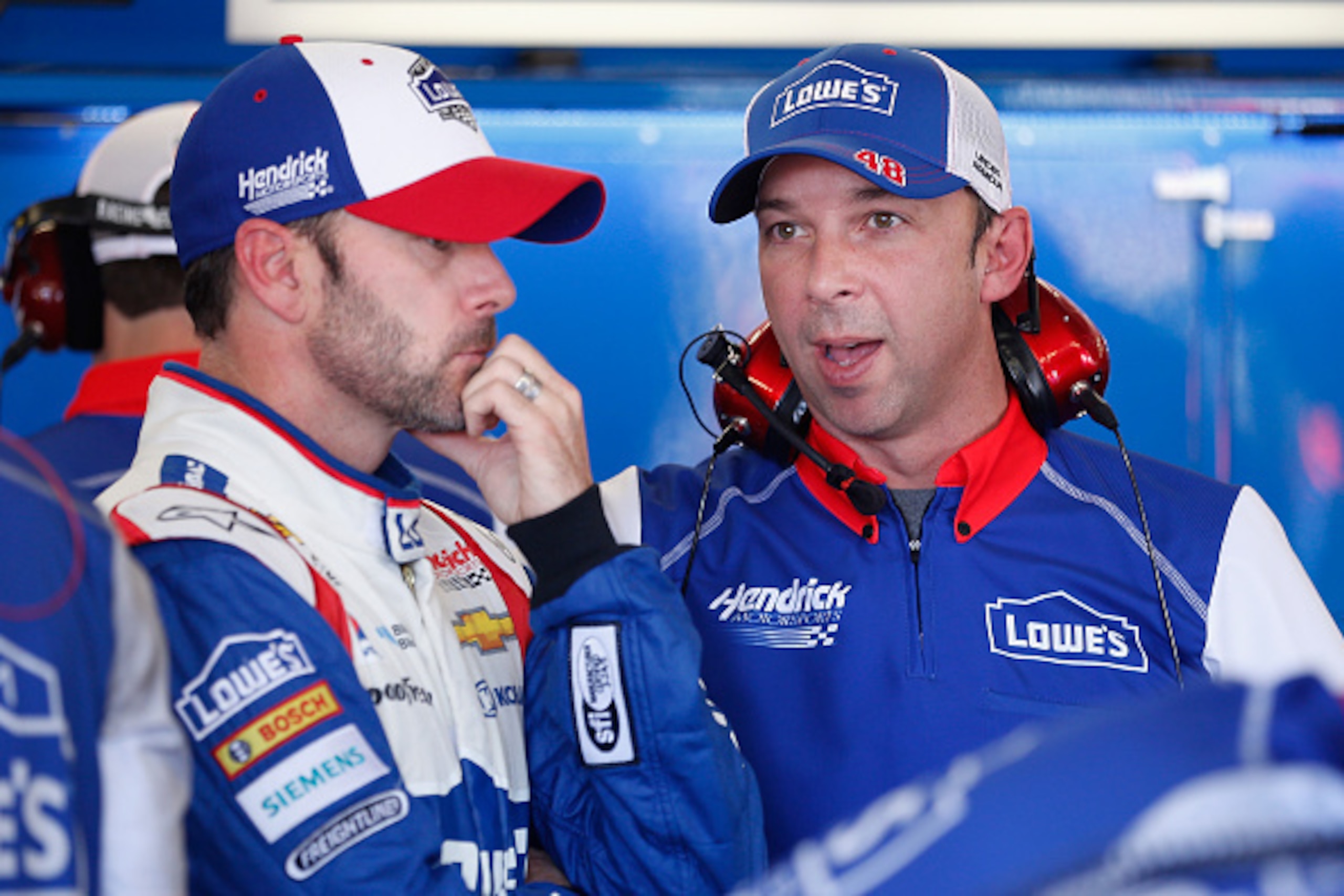 AVONDALE, AZ - NOVEMBER 13:  Jimmie Johnson, driver of the #48 Lowe's Patriotic Chevrolet, and crew chief Chad Knaus speak in the garage area during practice for the NASCAR Sprint Cup Series Quicken Loans Race for Heroes 500 at Phoenix International Racew