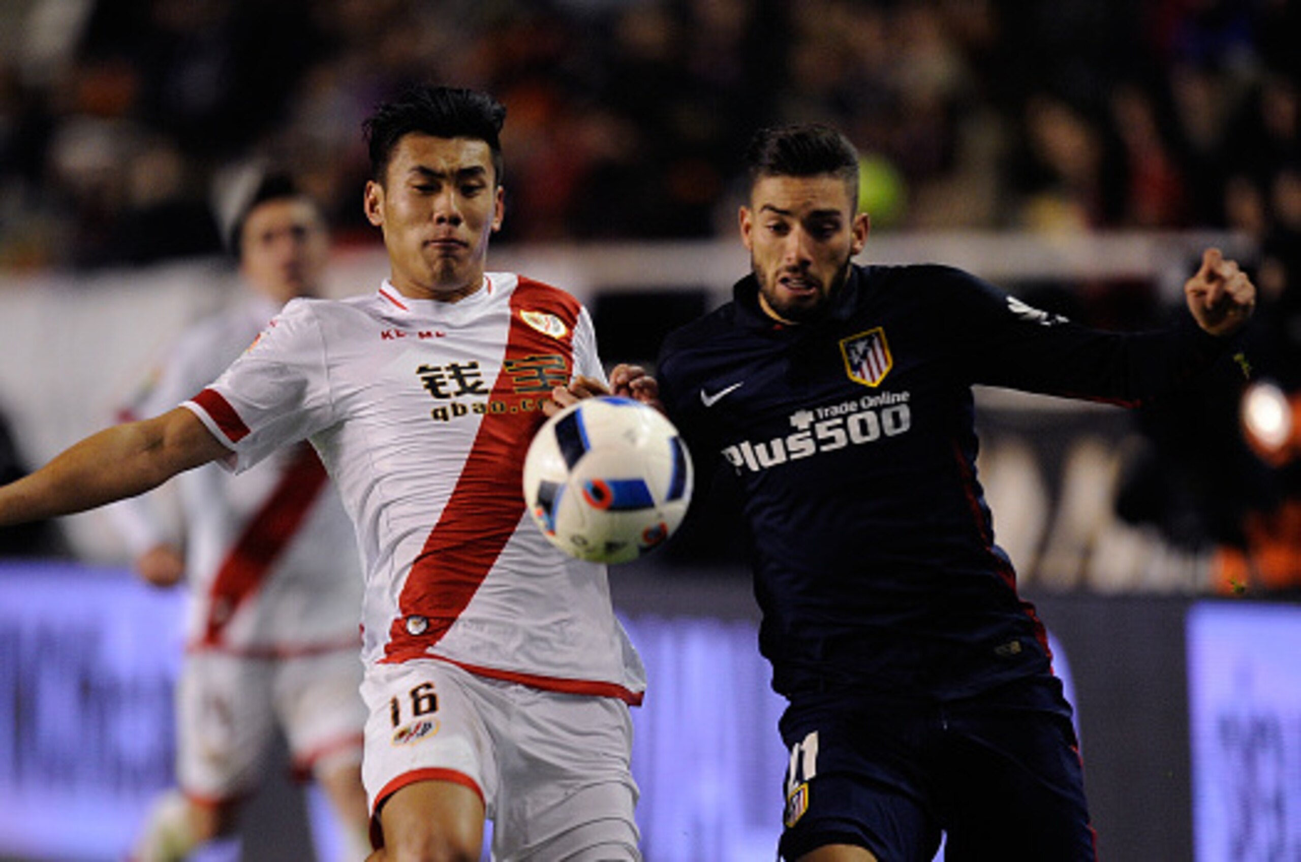 MADRID, SPAIN - JANUARY 06:  Zhang Chengdong of Rayo Vallecano de Madrid battles for the ball against Yannick Carrasco of Club Atletico de Madrid during the Copa del Rey, Round of 16 First Leg match, between Rayo Vallecano de Madrid and Club Atletico de M