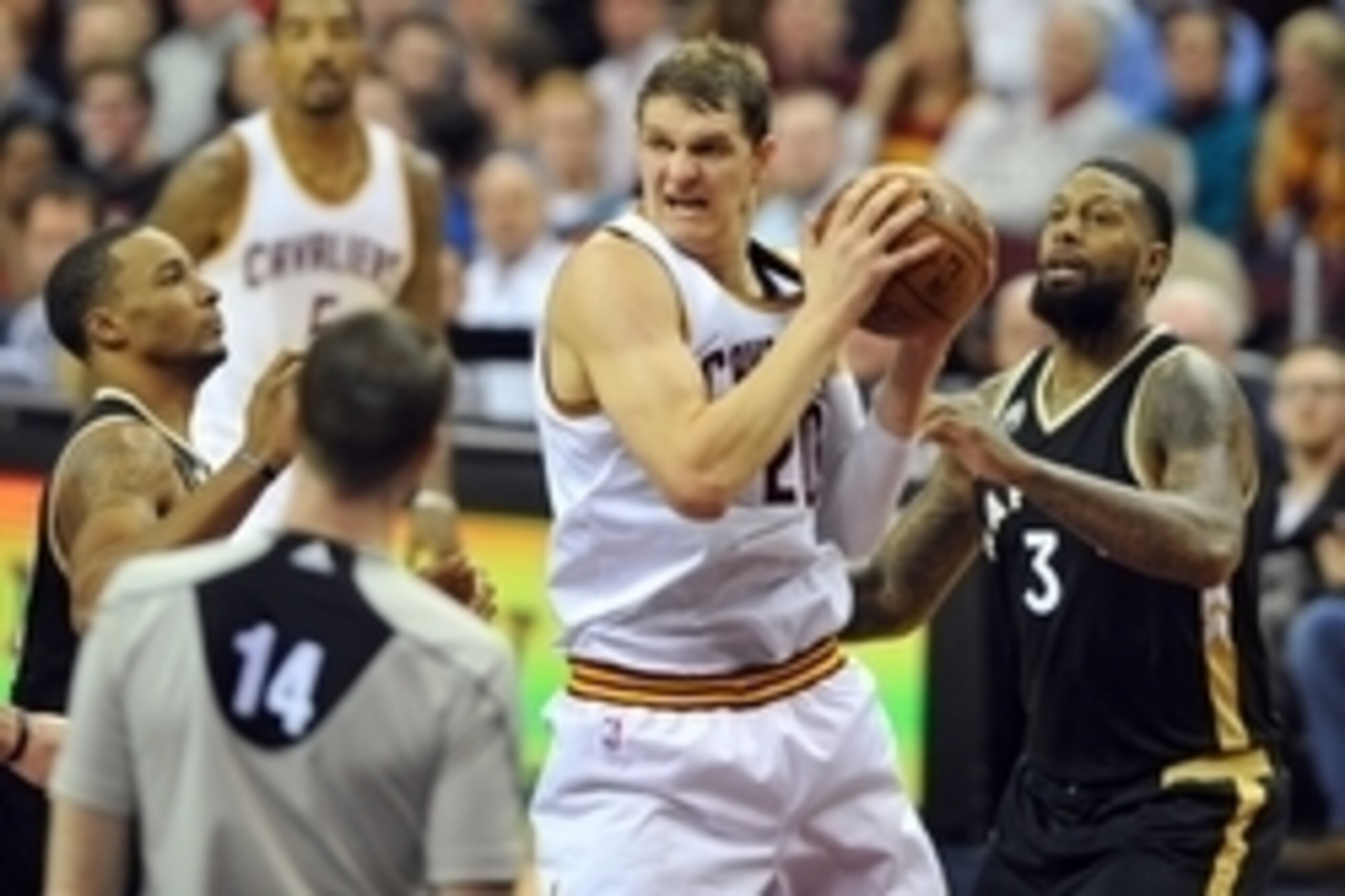Jan 4, 2016; Cleveland, OH, USA; Cleveland Cavaliers center Timofey Mozgov (20) grabs a rebound ahead of Toronto Raptors forward James Johnson (3) during the fourth quarter at Quicken Loans Arena. Mandatory Credit: Ken Blaze-USA TODAY Sports
