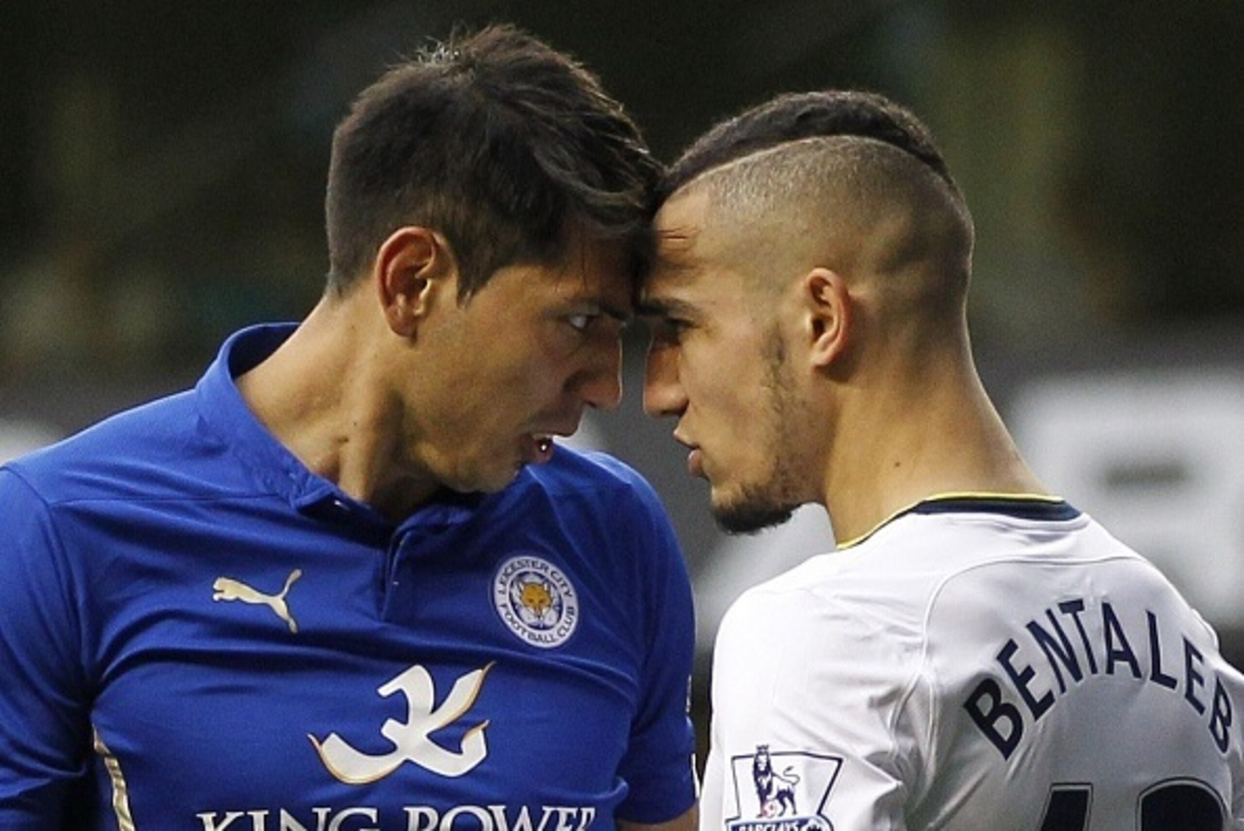 Tottenham Hotspur's French midfielder Nabil Bentaleb confronts Leicester City's Argentinian striker Leonardo Ulloa (L) during the English Premier League football match between Tottenham Hotspur and Leicester City at White Hart Lane in London on March 21, 