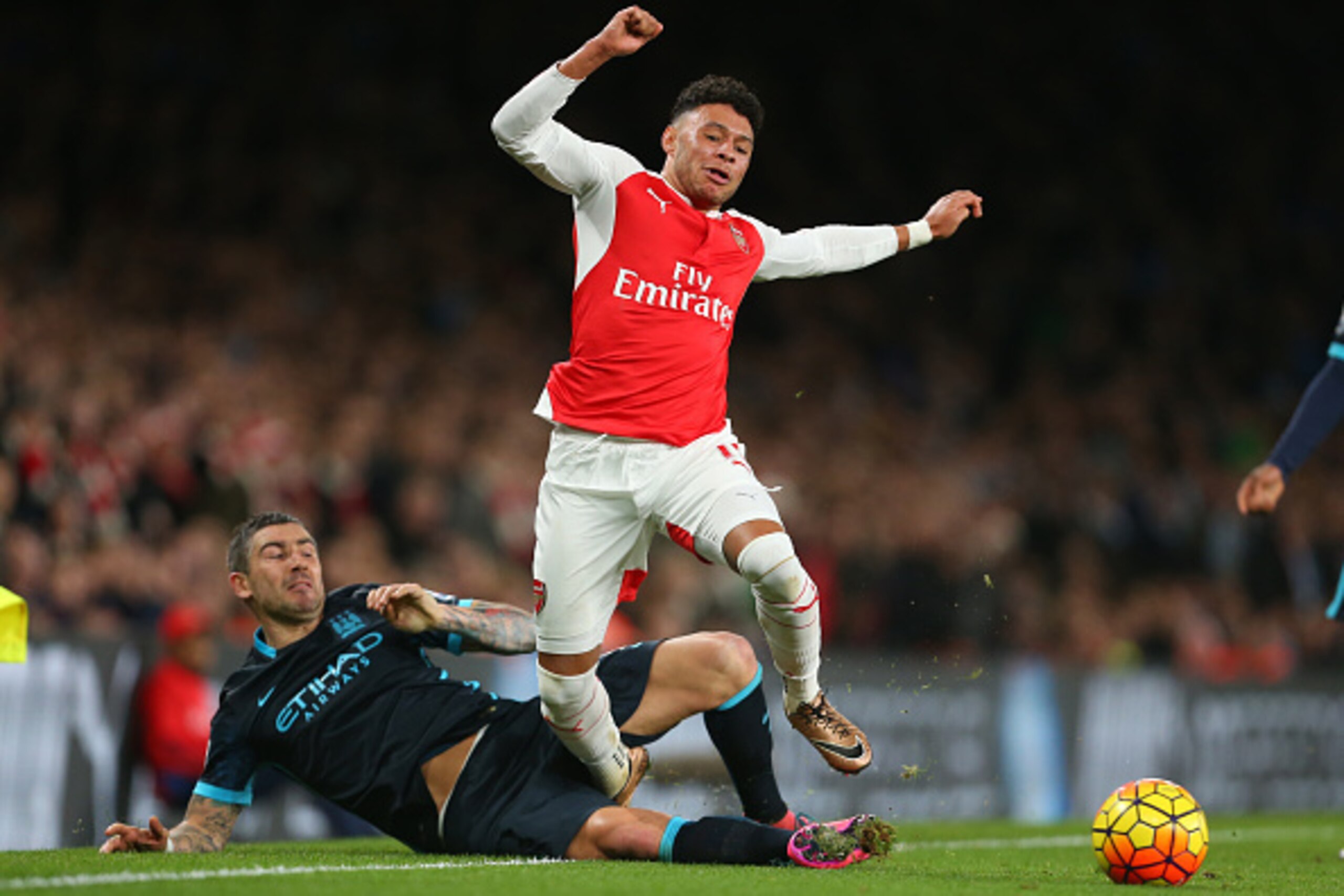 LONDON, ENGLAND - DECEMBER 21:  Aleksandar Kolarov of Manchester City tackles Alex Oxlade-Chamberlain of Arsenal during the Barclays Premier League match between Arsenal and Manchester City at the Emirates Stadium on December 21, 2015 in London, England. 