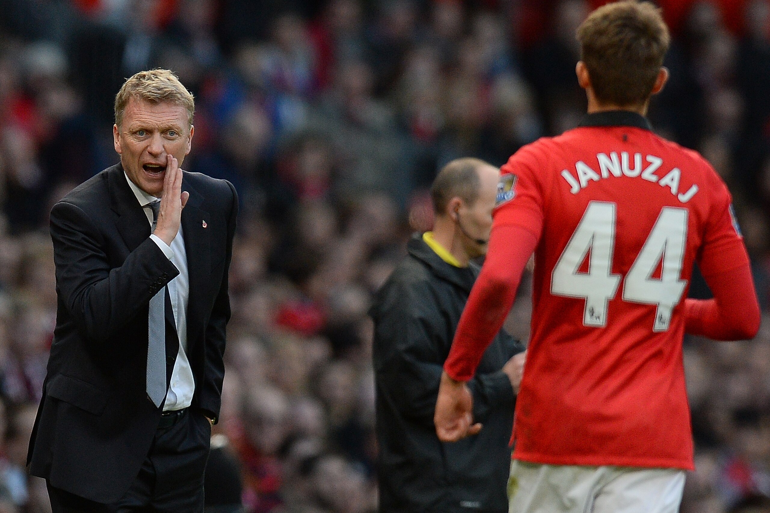 Manchester United Scottish manager David Moyes (L) speaks to Manchester United's Belgium midfielder Adnan Januzaj (R) during the English Premier League football match between Manchester United and Stoke City at Old Trafford in Manchester, northwest Englan