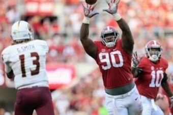 Sep 26, 2015; Tuscaloosa, AL, USA; Alabama Crimson Tide defensive lineman Jarran Reed (90) knocks down the pass of Louisiana Monroe Warhawks quarterback Garrett Smith (13) at Bryant-Denny Stadium. The Tide defeated the Warhawks 34-0. Mandatory Credit: Mar