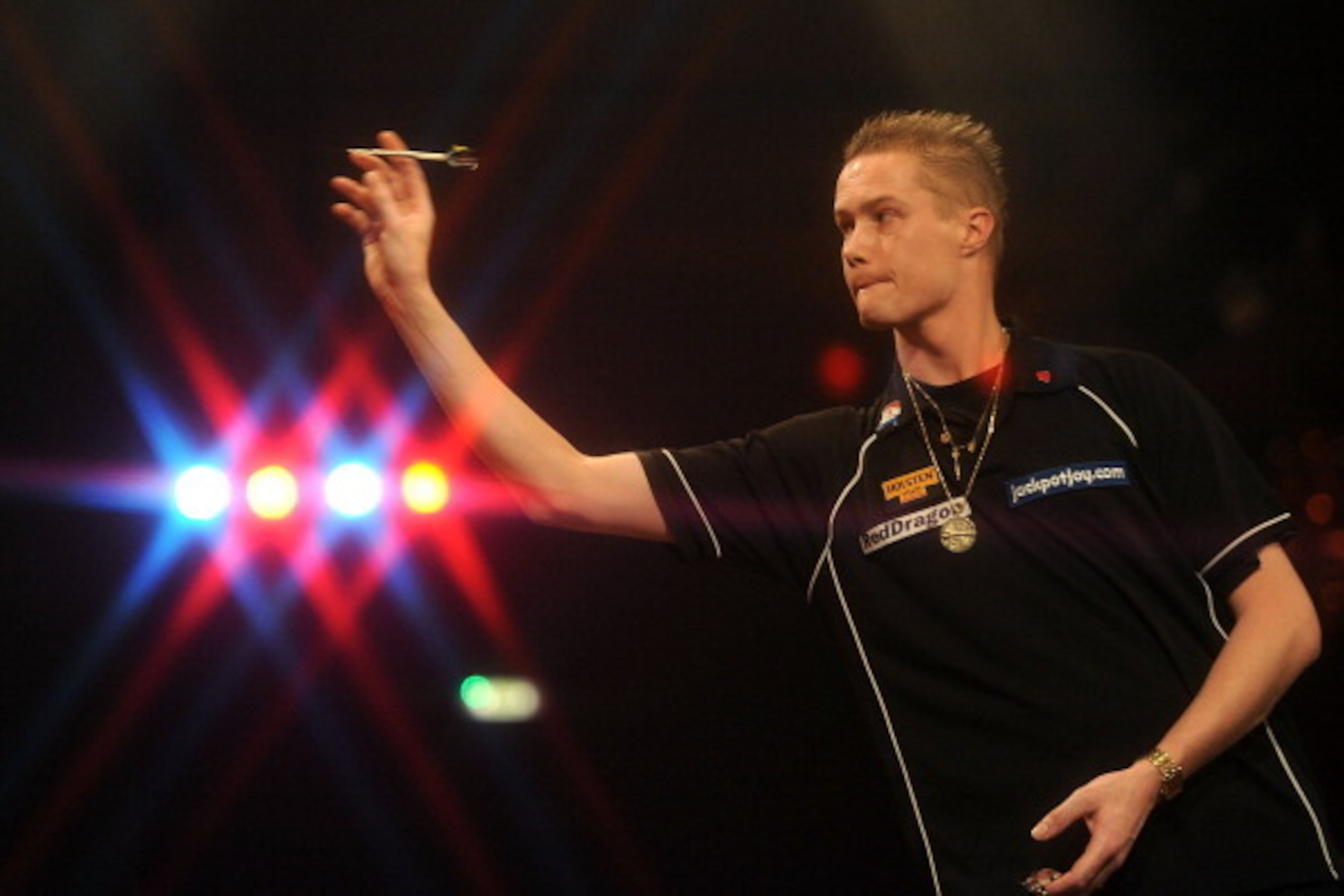 FRIMLEY, ENGLAND - JANUARY 04: Wesley Harms of Netherlands in action against Paul Jennings of England on day one of the BDO Lakeside World Professional Darts Championships at  Lakeside Complex on January 4, 2014 in Frimley, England. (Photo by Tom Dulat/Ge