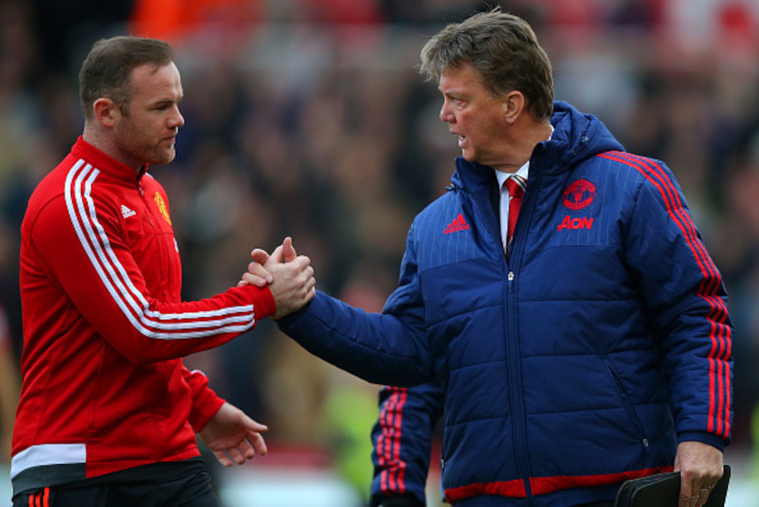 STOKE ON TRENT, ENGLAND - DECEMBER 26:  Louis van Gaal, manager of Manchester United shakes hands with Wayne Rooney of Manchester United during the Barclays Premier League match between Stoke City and Manchester United at Britannia Stadium on December 26,