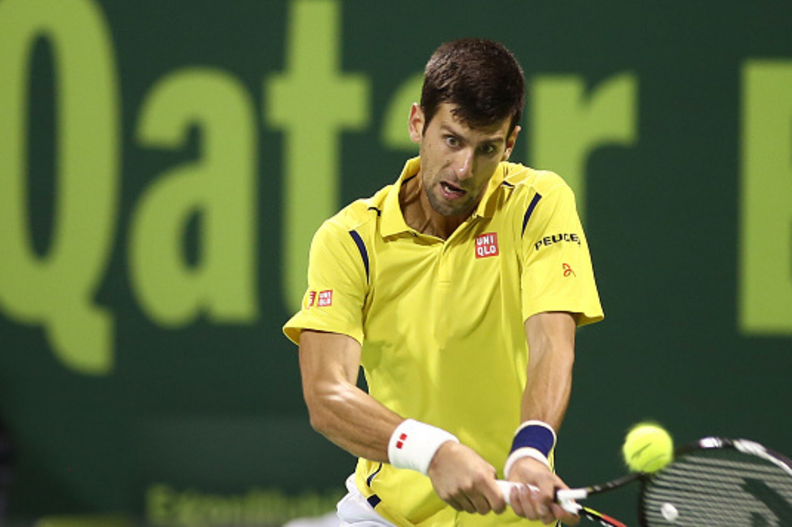 Novak Djokovic of Serbia returns the ball to Argentina's Leonardo Mayer as they compete in their tennis match during the Qatar Open tournament on January 7, 2016, in Doha. AFP PHOTO / KARIM JAAFAR / AFP / KARIM JAAFAR        (Photo credit should read KARI