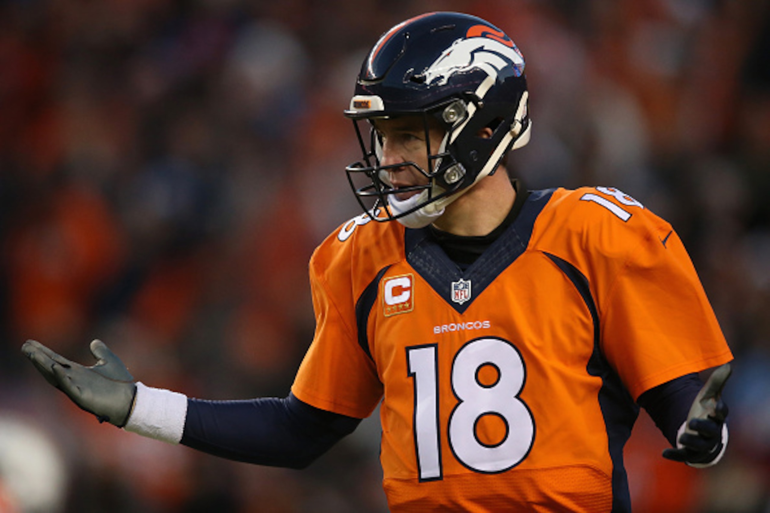 DENVER, CO - JANUARY 03:  Quarterback Peyton Manning #18 of the Denver Broncos reacts after a one yard touchdown run by C.J. Anderson #22 of the Denver Broncos to take a 14-13 lead over the San Diego Chargers in the third quarter at Sports Authority Field