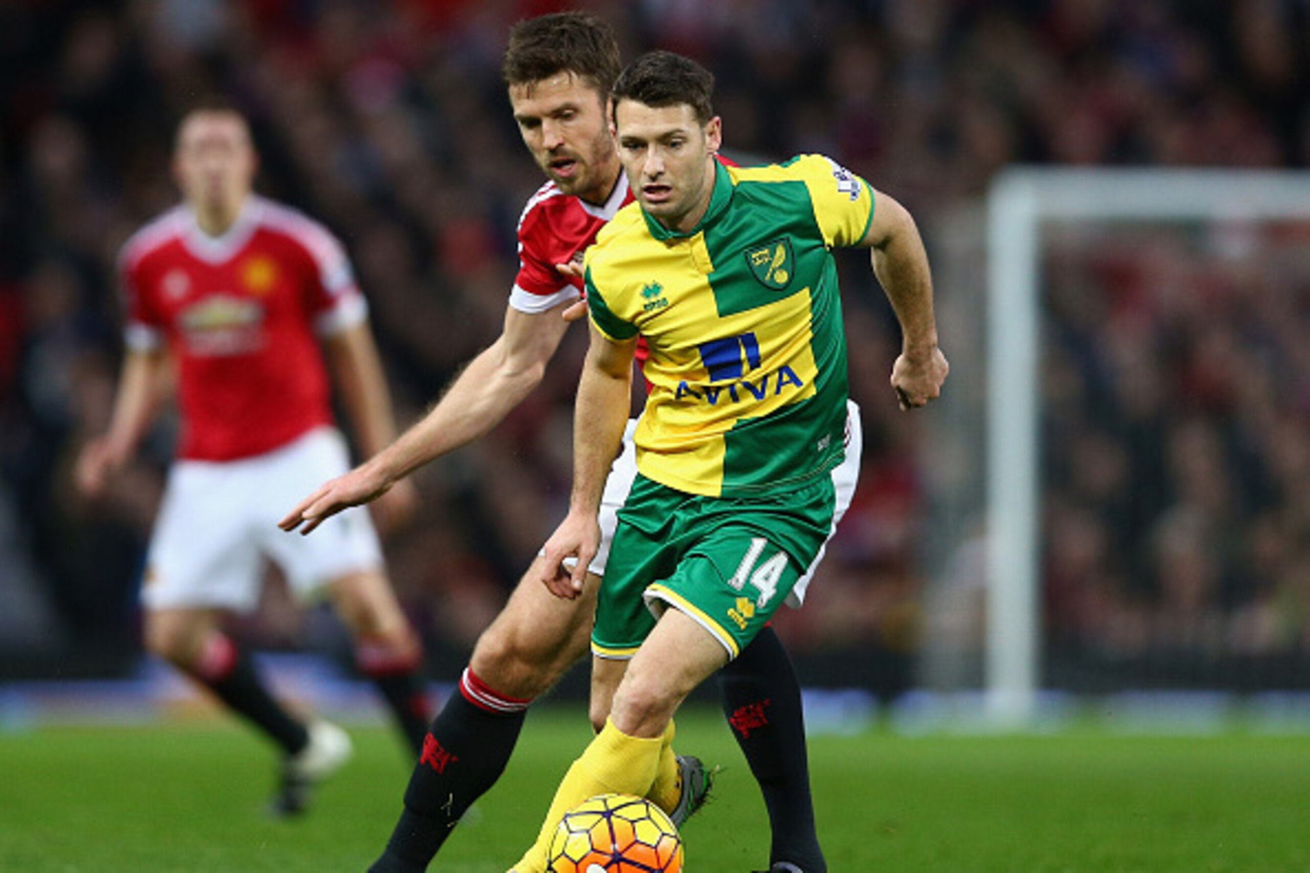 MANCHESTER, ENGLAND - DECEMBER 19: Wes Hoolahan of Norwich City and Michael Carrick of Manchester United compete for the ball during the Barclays Premier League match between Manchester United and Norwich City at Old Trafford on December 19, 2015 in Manch