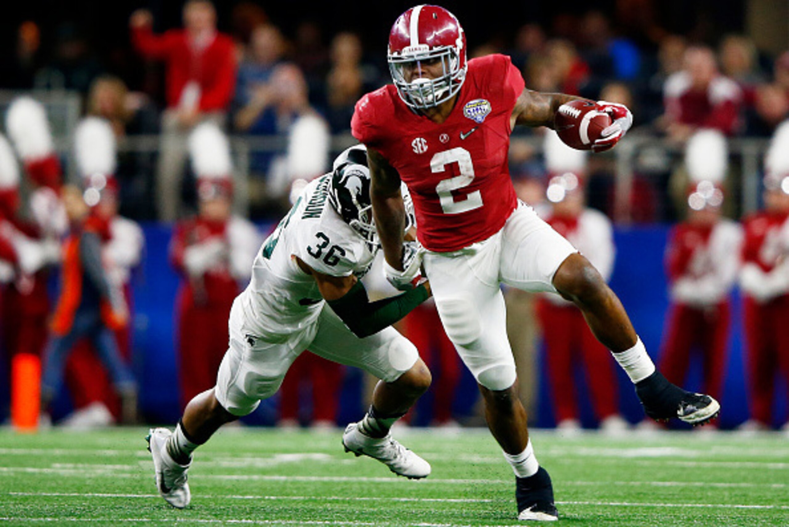 ARLINGTON, TX - DECEMBER 31:  Running back Derrick Henry #2 of the Alabama Crimson Tide runs the ball ahead of cornerback Arjen Colquhoun #36 of the Michigan State Spartans in the second quarter during the Goodyear Cotton Bowl at AT&T Stadium on December 