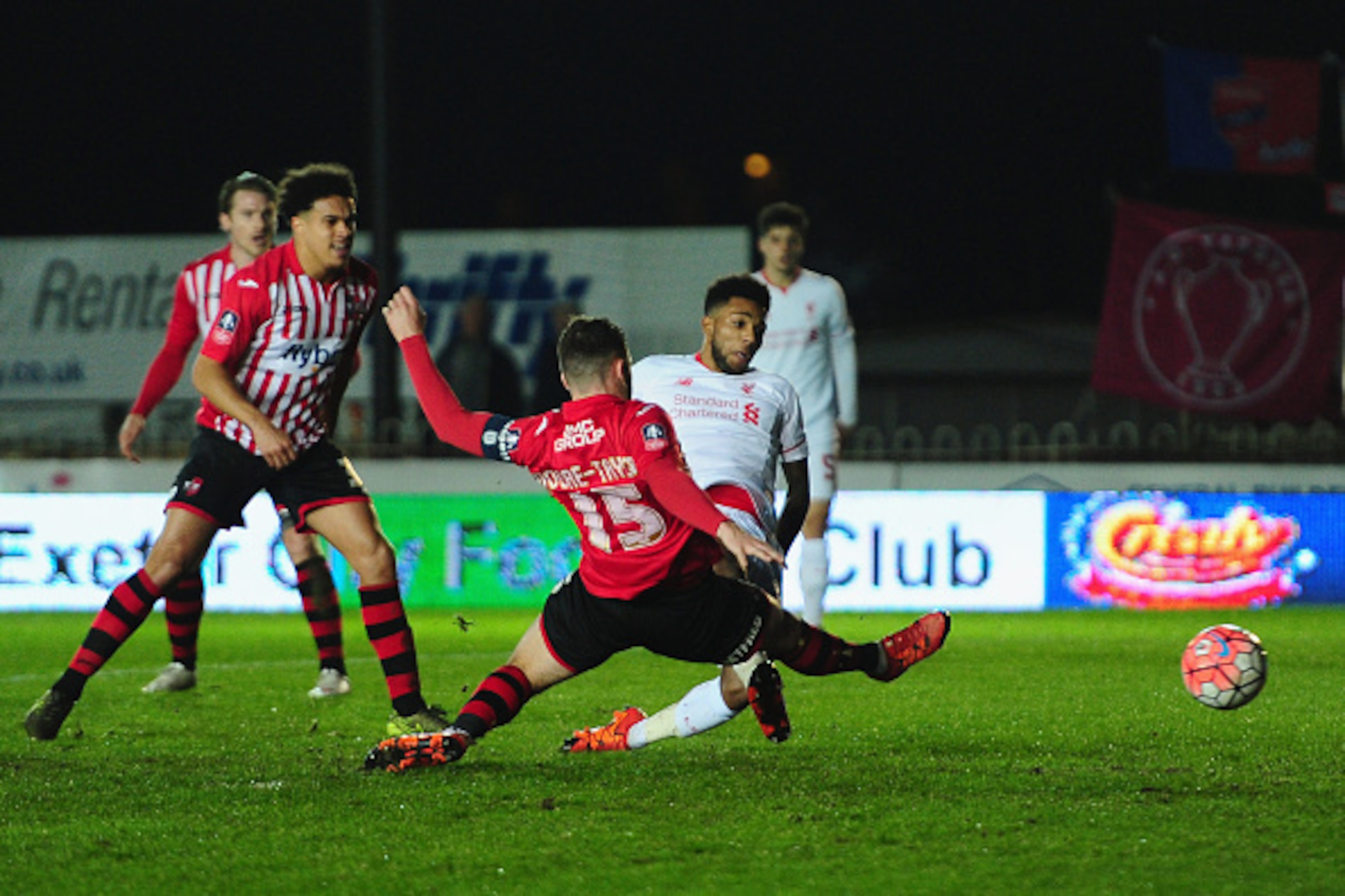 EXETER, ENGLAND - JANUARY 08:  Jerome Sinclair of Liverpool beats Jordan Moore-Taylor of Exeter City (15) to score their first and equalising goal during the Emirates FA Cup third round match between Exeter City and Liverpool at St James Park on January 8