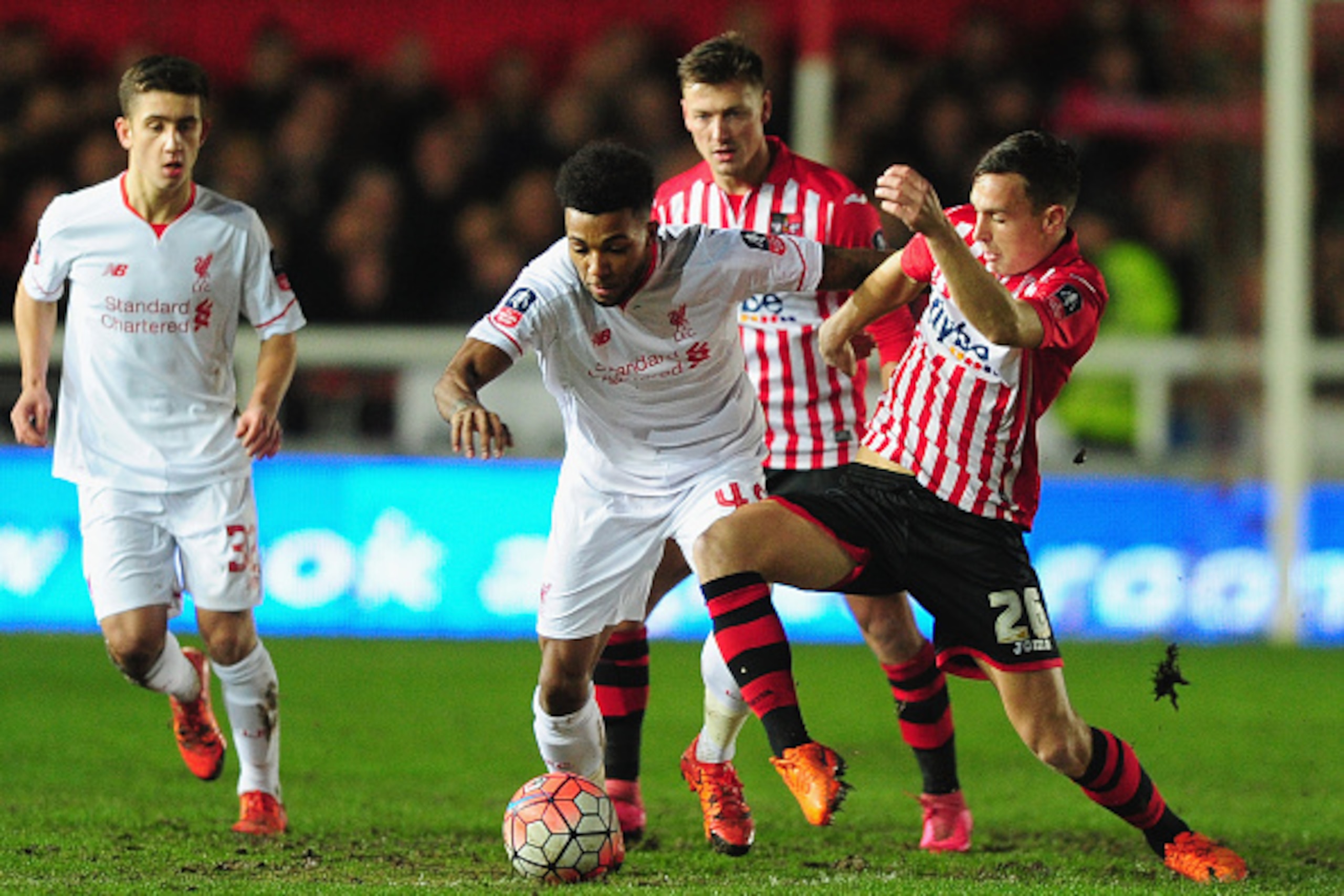 EXETER, ENGLAND - JANUARY 08:  Jerome Sinclair of Liverpool holds off Jordan Tillson of Exeter City during the Emirates FA Cup third round match between Exeter City and Liverpool at St James Park on January 8, 2016 in Exeter, England.  (Photo by Dan Mulla