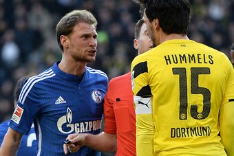 DORTMUND, GERMANY - FEBRUARY 28:  (L-R) Benedikt Hoewedes of Schalke and Mats Hummels of Dortmund have a disagreement during the Bundesliga match between Borussia Dortmund and FC Schalke 04 at Signal Iduna Park on February 28, 2015 in Dortmund, Germany.  