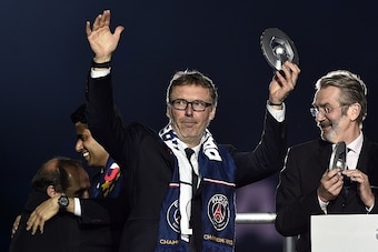Paris Saint-Germain's French head coach Laurent Blanc holds the trophy on the podium after winning the French L1 title at the end of the French L1 football match Paris Saint-Germain (PSG) vs Reims on May 23, 2015 at the Parc des Princes stadium in Paris. 