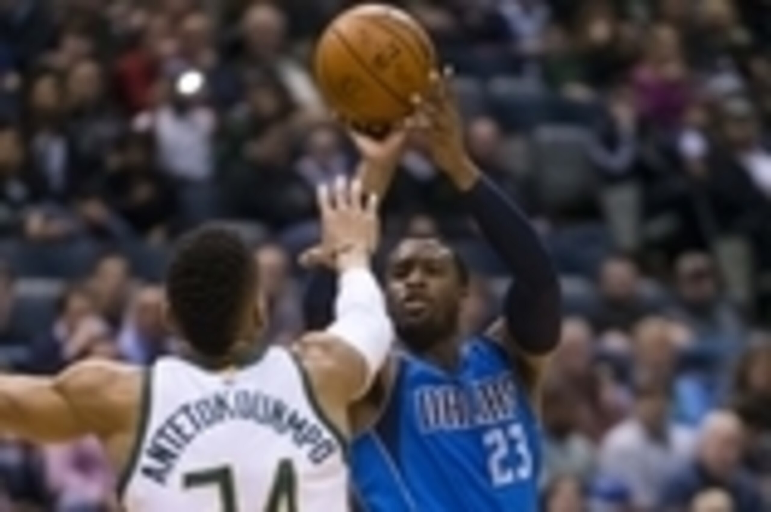 Jan 8, 2016; Milwaukee, WI, USA; Dallas Mavericks guard Wesley Matthews (23) shoots against Milwaukee Bucks forward Giannis Antetokounmpo (34) during the first quarter at BMO Harris Bradley Center. Mandatory Credit: Jeff Hanisch-USA TODAY Sports