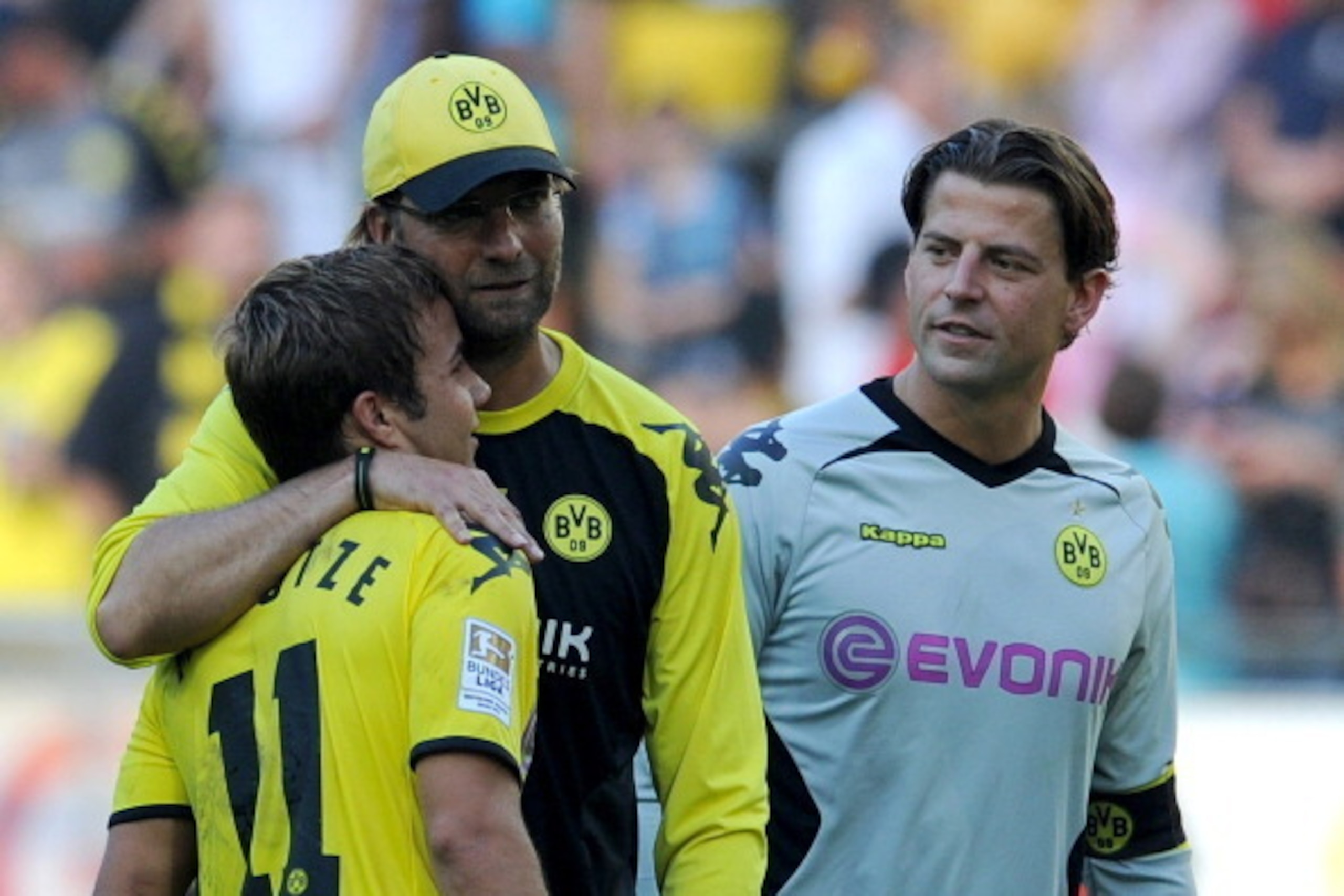 Dortmund's Mario Goetze, headcoach Juergen Klopp and goalkeeper Roman Weidenfeller celebrate after the German first division Bundesliga football match Borussia Dortmund vs FC Augsburg in the western German city of Dortmund on October 1, 2011. Dortmund won