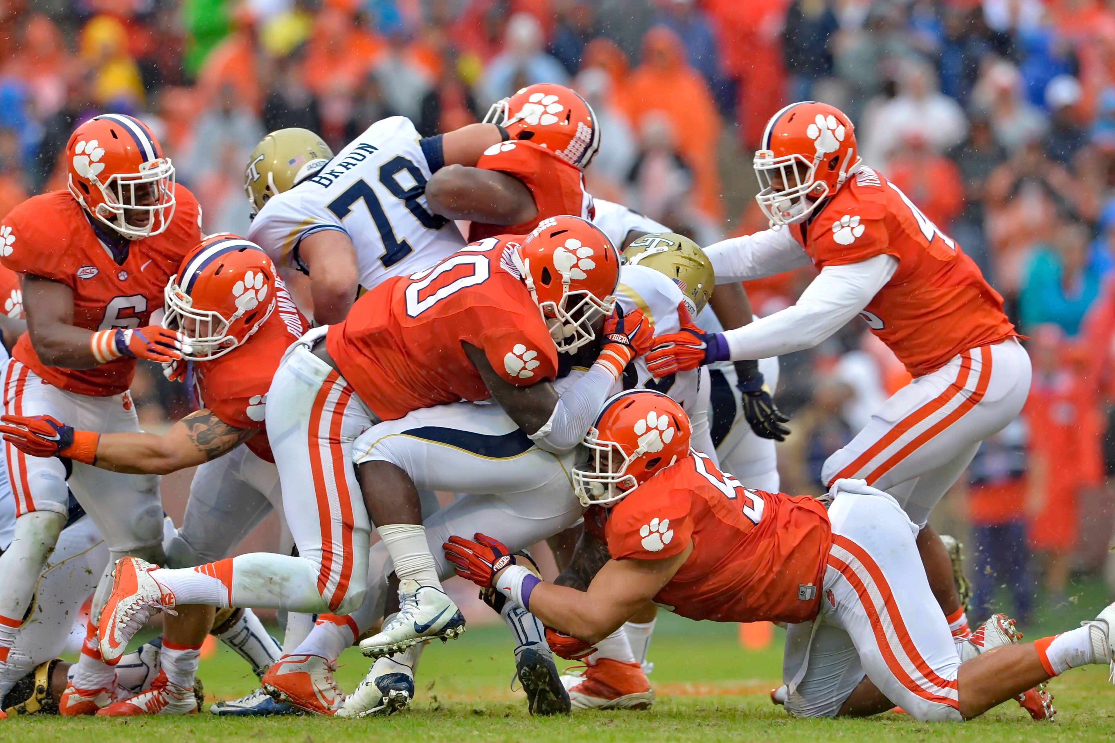 The Clemson defensive line swarms a Georgia Tech running back. The Clemson defensive line swarms a Georgia Tech running back.