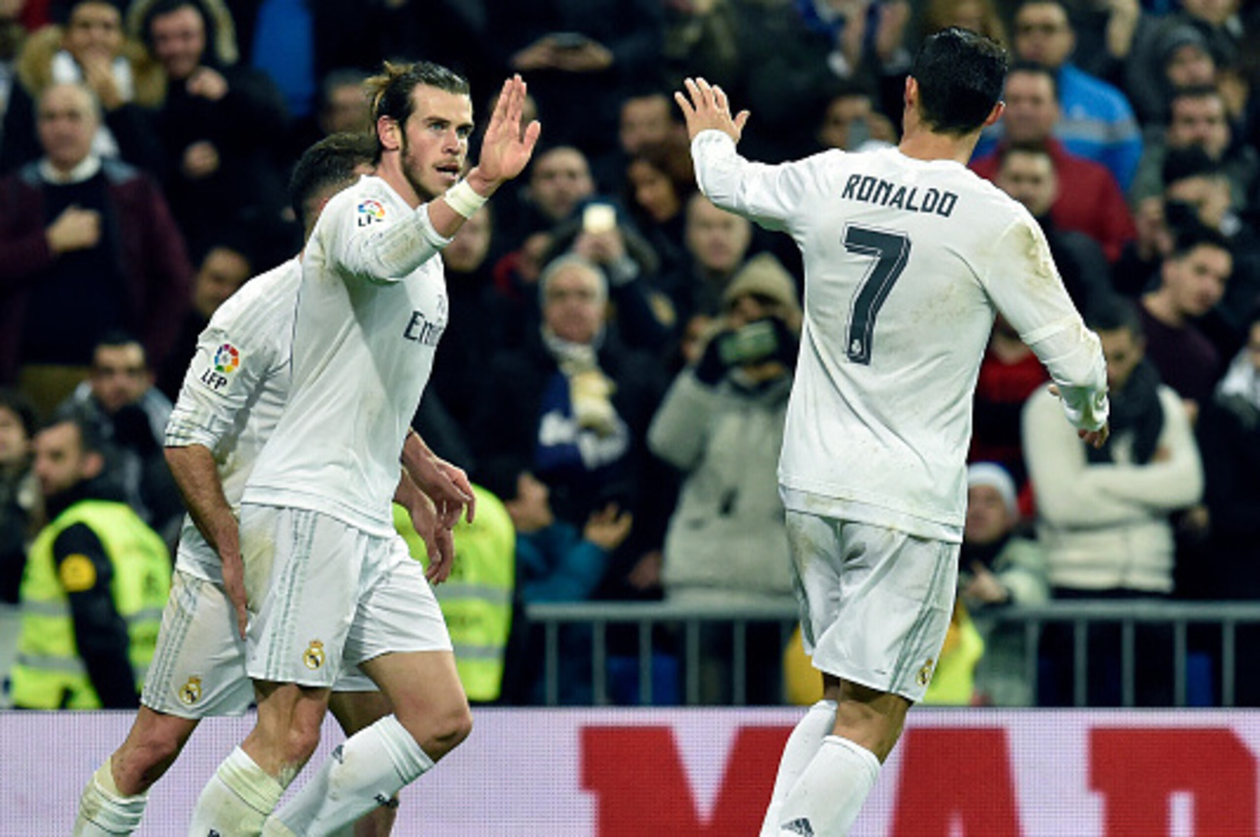 Real Madrid's Welsh forward Gareth Bale (L) is congratulated by Real Madrid's Portuguese forward Cristiano Ronaldo during the Spanish league football match Real Madrid CF vs RC Deportivo La Coruna at the Santiago Bernabeu stadium in Madrid on January 9, 2