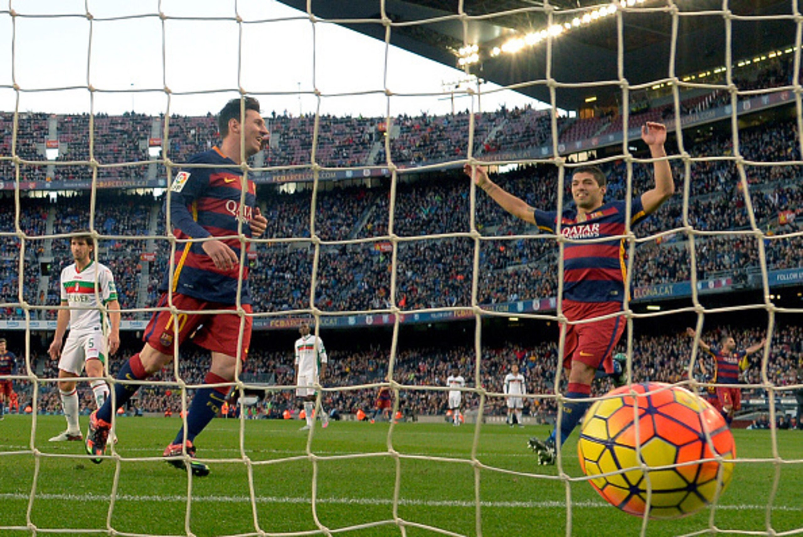 Barcelona's Argentinian forward Lionel Messi (L) celebrates with Barcelona's Uruguayan forward Luis Suarez (R) after scoring a goal during the Spanish league football match FC Barcelona vs Granada CF at the Camp Nou stadium in Barcelona on January 9, 2016