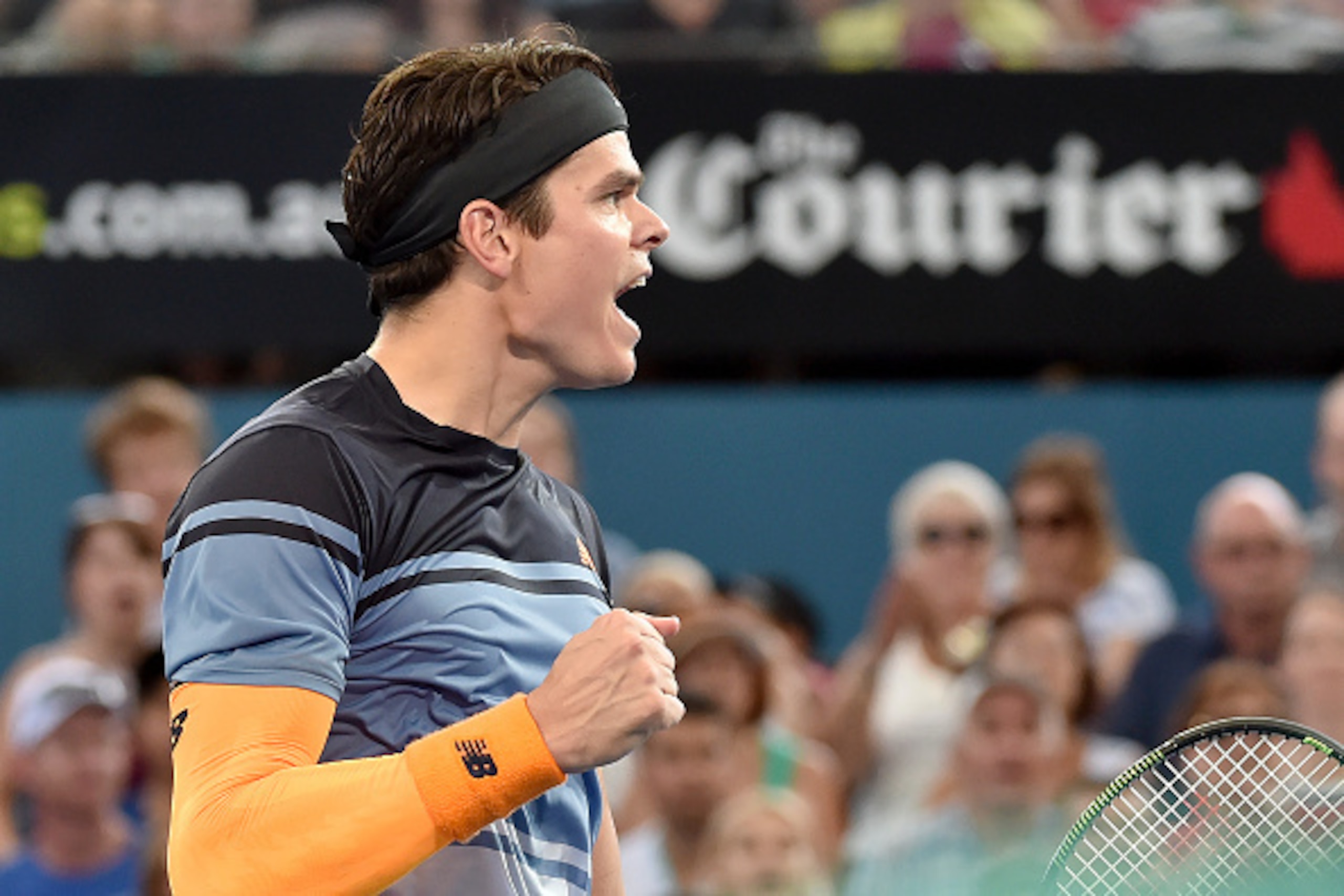 Milos Raonic of Canada celebrates his victory against Australia's Bernard Tomic in their men's singles semi-final match on the seventh day of the Brisbane International tennis tournament on January 9, 2016. AFP PHOTO / Saeed KHAN
-- IMAGE RESTRICTED TO ED