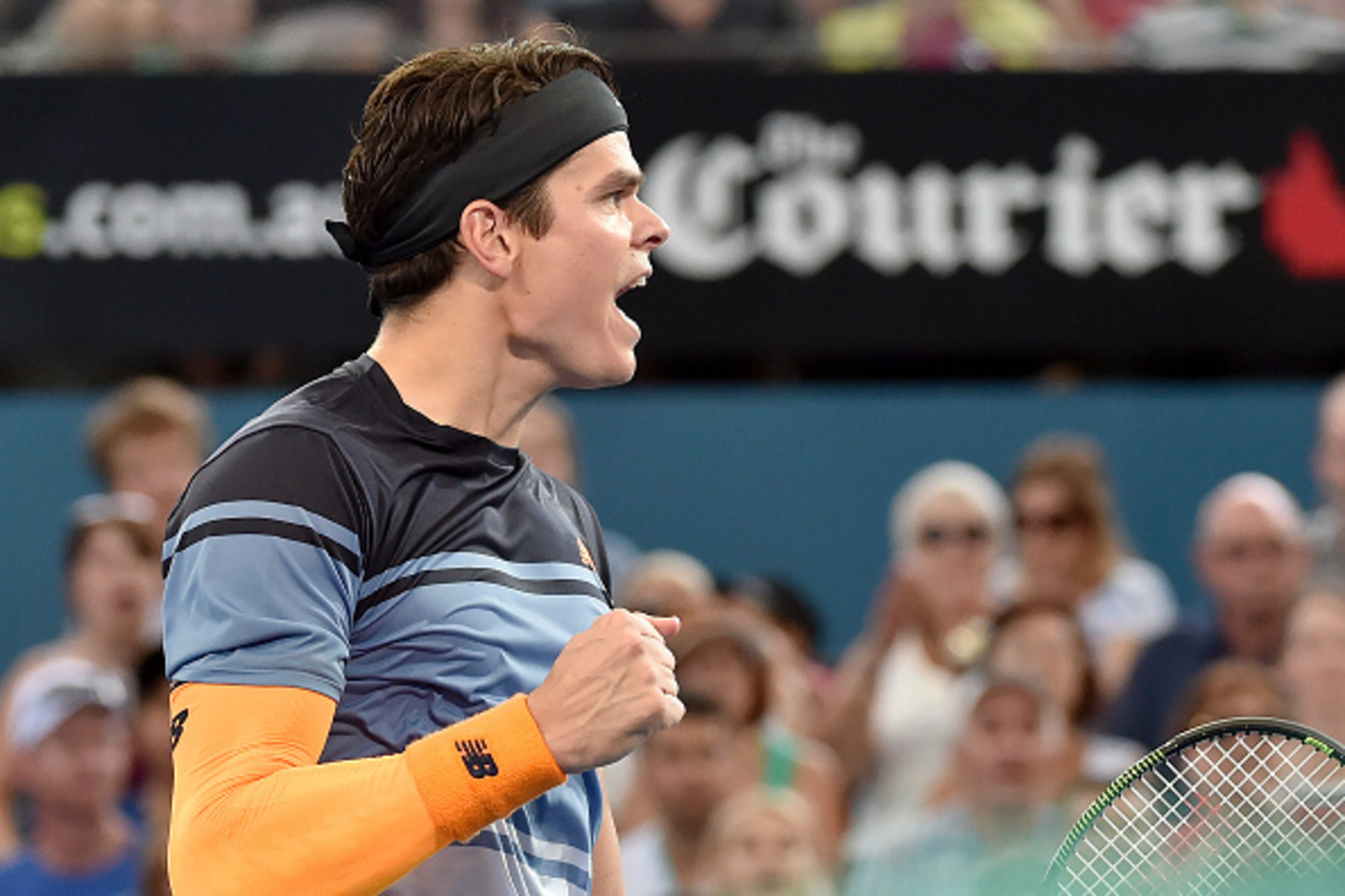 Milos Raonic of Canada celebrates his victory against Australia's Bernard Tomic in their men's singles semi-final match on the seventh day of the Brisbane International tennis tournament on January 9, 2016. AFP PHOTO / Saeed KHAN
-- IMAGE RESTRICTED TO ED