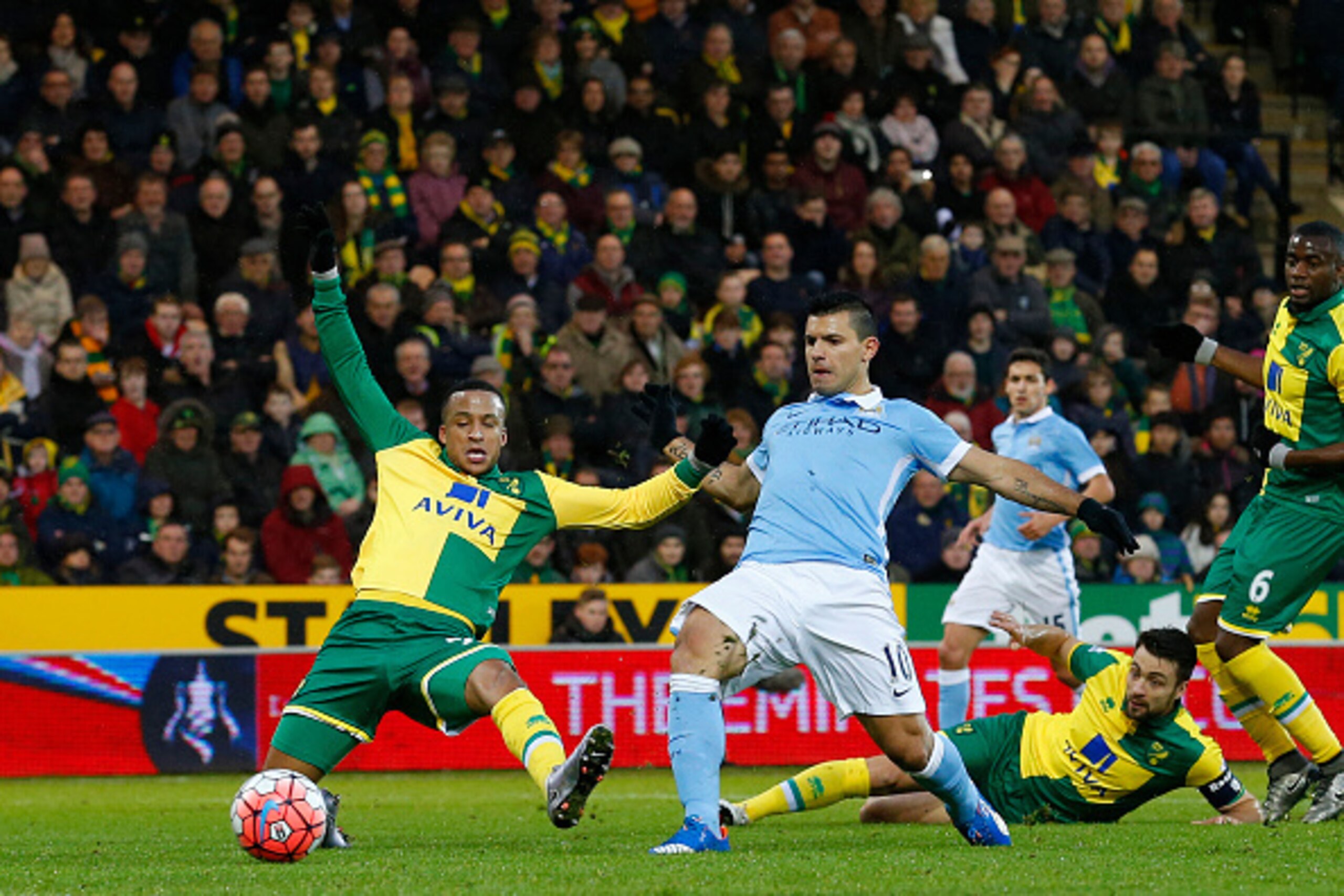 Manchester City's Argentinian striker Sergio Aguero (2L) scores his team's first goal during the FA Cup third-round football match between Norwich City and Manchester City at Carrow Road in Norwich, eastern England on January 9, 2016. AFP PHOTO / LINDSE Manchester City's Argentinian striker Sergio Aguero (2L) scores his team's first goal during the FA Cup third-round football match between Norwich City and Manchester City at Carrow Road in Norwich, eastern England on January 9, 2016. AFP PHOTO / LINDSE