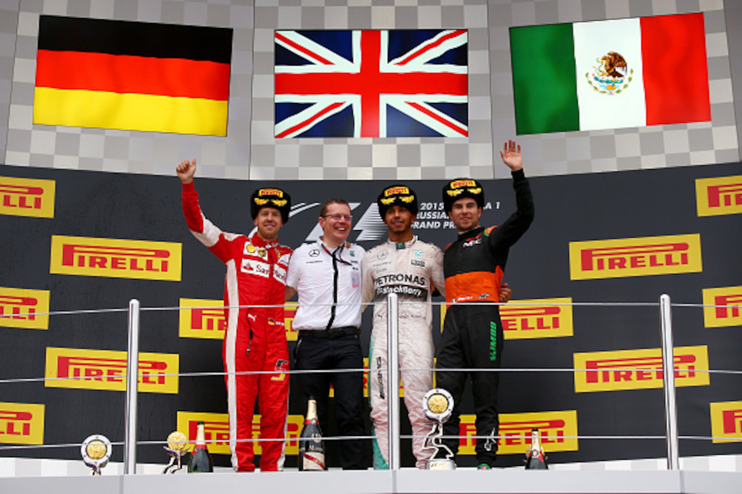 SOCHI, RUSSIA - OCTOBER 11:  Lewis Hamilton of Great Britain and Mercedes GP celebrates on the podium next to Sebastian Vettel of Germany and Ferrari and Sergio Perez of Mexico and Force India after winning the Formula One Grand Prix of Russia at Sochi Au