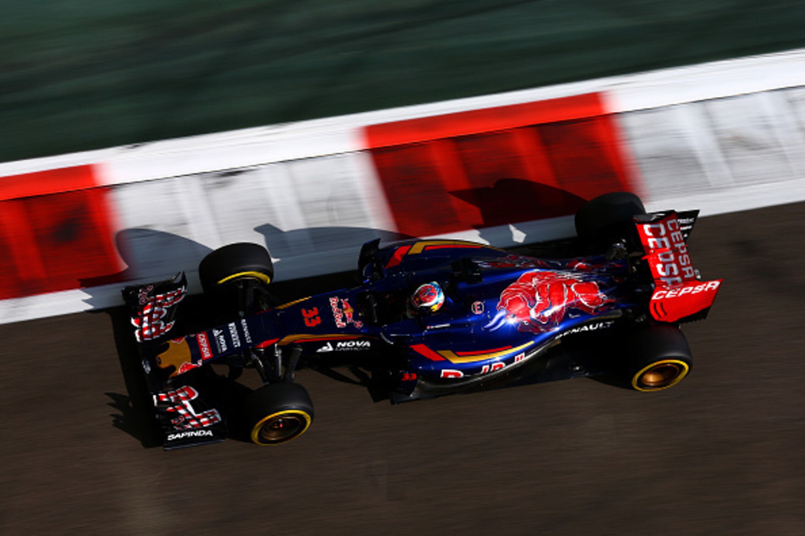 ABU DHABI, UNITED ARAB EMIRATES - NOVEMBER 27:  Max Verstappen of Netherlands and Scuderia Toro Rosso drives during practice for the Abu Dhabi Formula One Grand Prix at Yas Marina Circuit on November 27, 2015 in Abu Dhabi, United Arab Emirates.  (Photo by