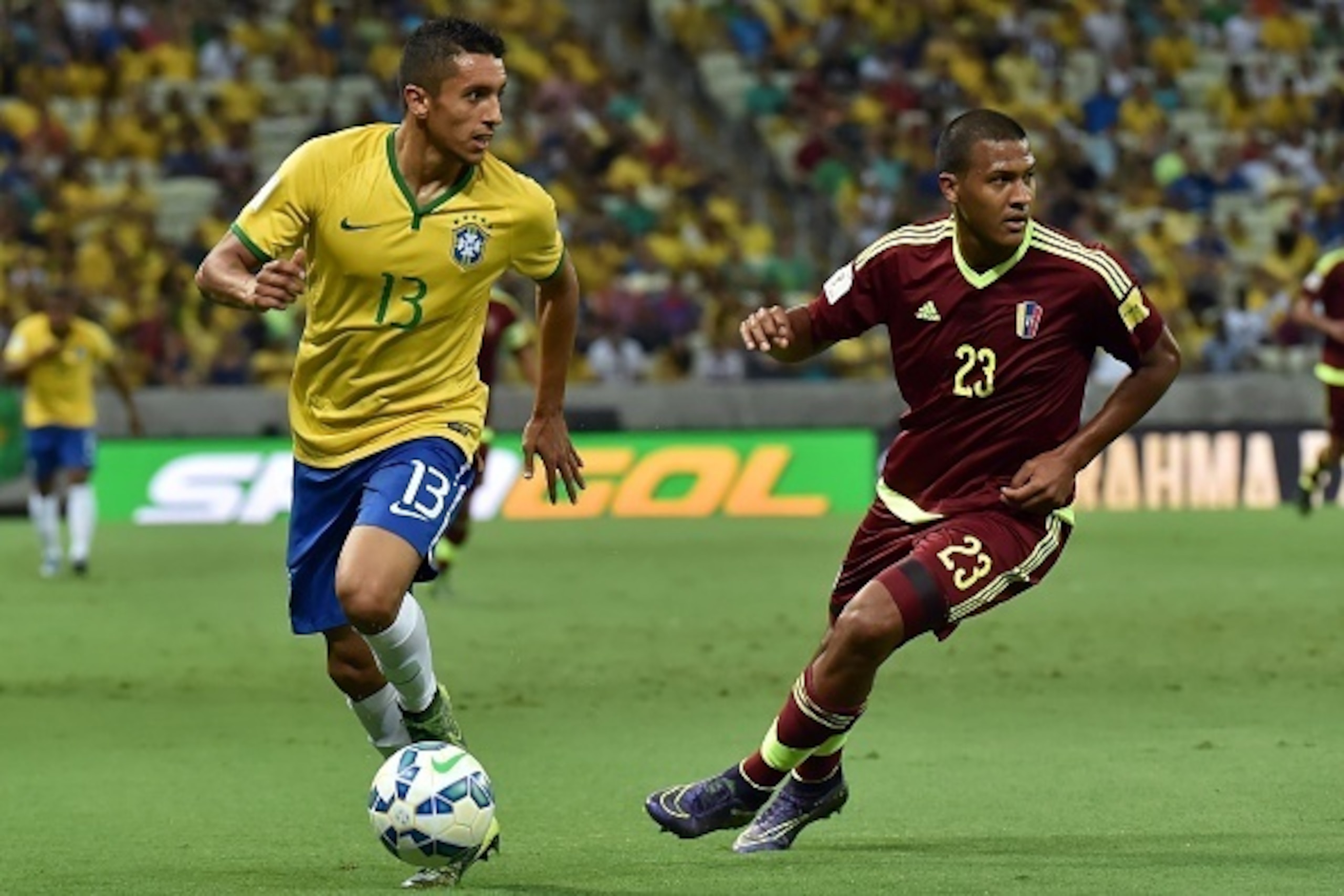 Brazil's Marquinhos and Venezuela's Jose Rondon vie for the ball during their Russia 2018 FIFA World Cup South American Qualifiers football match, at the Estadio Castelao stadium in Fortaleza, Brazil, on October 13, 2015. AFP PHOTO / NELSON ALMEIDA
