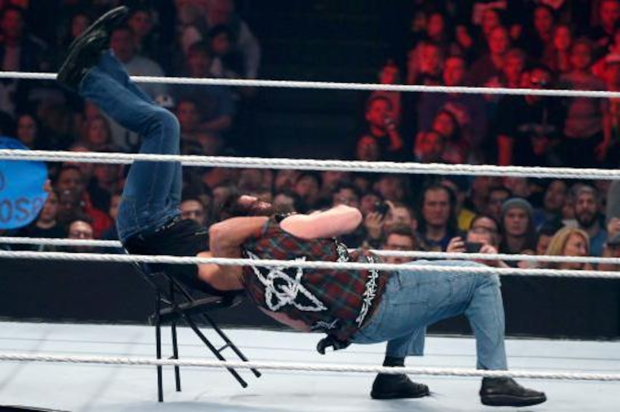 Luke Harper sends Dean Ambrose crashing through a steel chair.