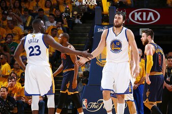 OAKLAND, CA - JUNE 7: Teammates Draymond Green #23 of the Golden State Warriors and Andrew Bogut #12 of the Golden State Warriors high-five during Game Two of the 2015 NBA Finals on June 7, 2015 at Oracle Arena in Oakland, California. NOTE TO USER: User e