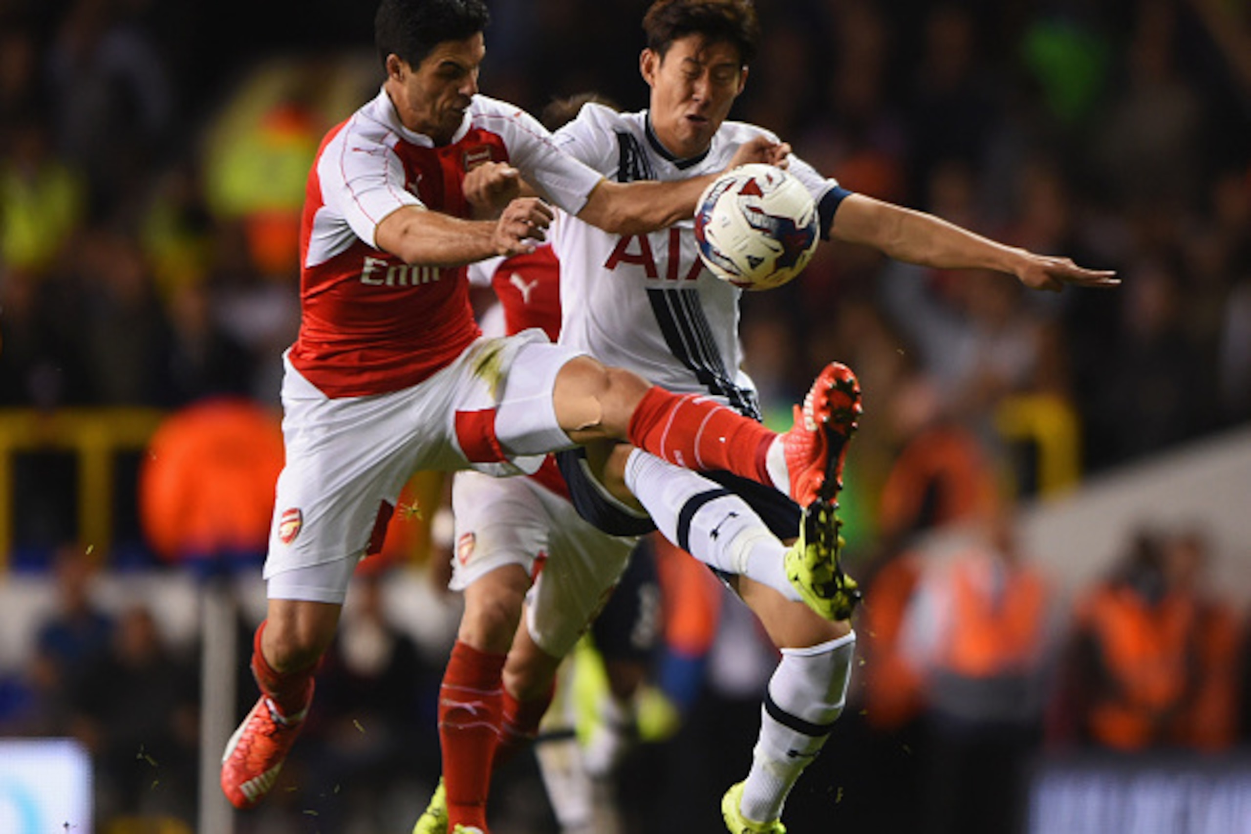LONDON, ENGLAND - SEPTEMBER 23:  Mikel Arteta of Arsenal and Son Heung-Min of Tottenham Hotspur battle for the ball during the Capital One Cup third round match between Tottenham Hotspur and Arsenal at White Hart Lane on September 23, 2015 in London, Engl