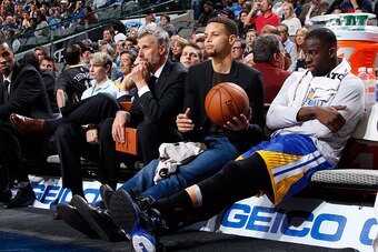 DALLAS, TX - DECEMBER 30:   Stephen Curry #30 of the Golden State Warriors sits on the bench during the game against the Dallas Mavericks on December 30, 2015 at the American Airlines Center in Dallas, Texas. NOTE TO USER: User expressly acknowledges and 