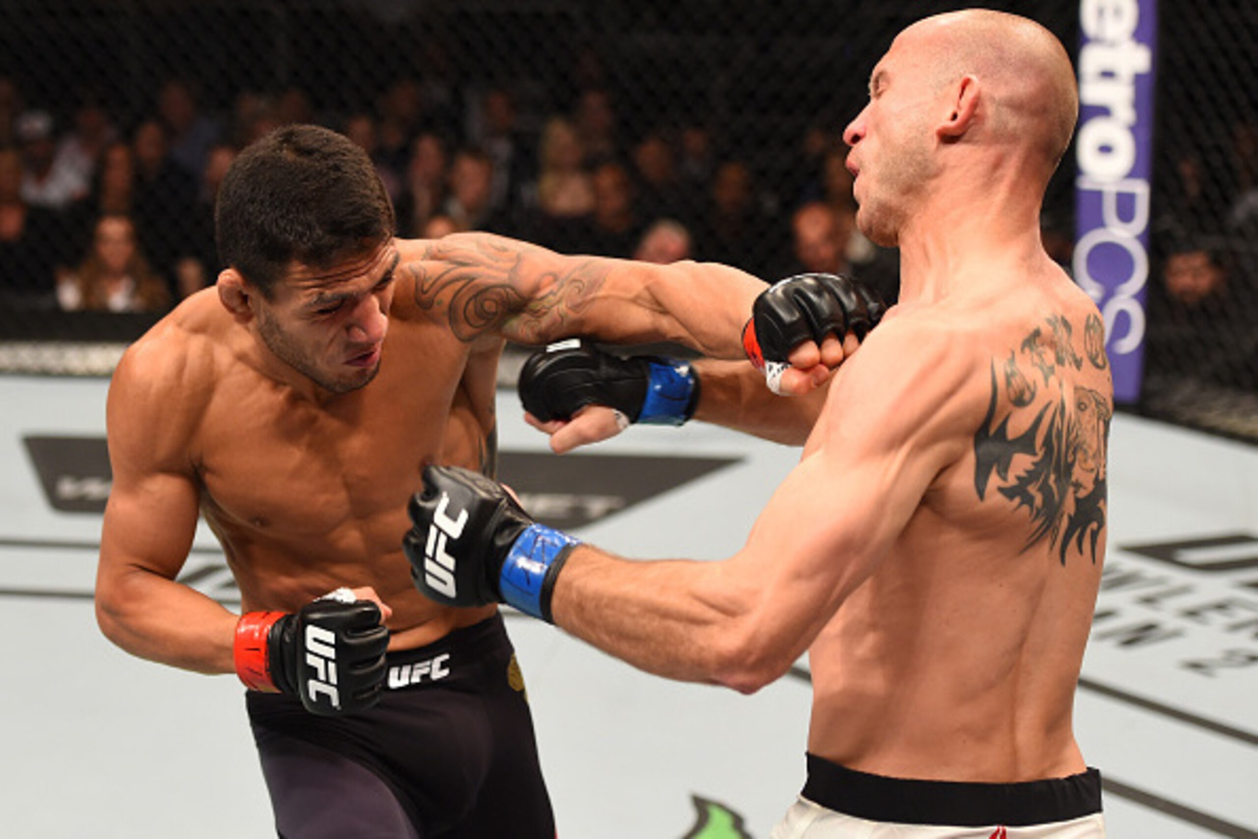 ORLANDO, FL - DECEMBER 19:   (L-R) Rafael dos Anjos punches Donald Cerrone in their UFC lightweight title bout during the UFC Fight Night event at the Amway Center on December 19, 2015 in Orlando, Florida. (Photo by Josh Hedges/Zuffa LLC/Zuffa LLC via Get