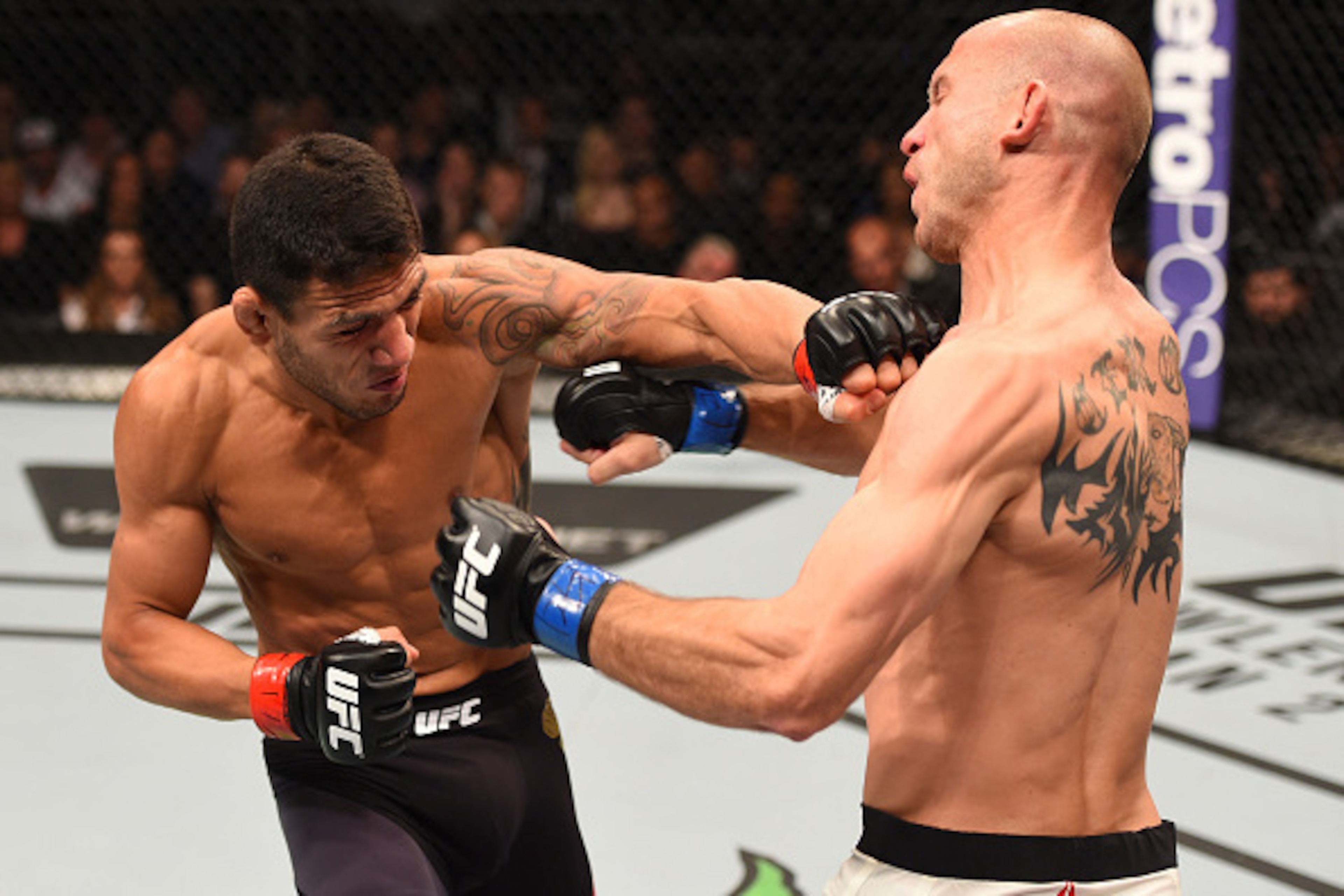 ORLANDO, FL - DECEMBER 19:   (L-R) Rafael dos Anjos punches Donald Cerrone in their UFC lightweight title bout during the UFC Fight Night event at the Amway Center on December 19, 2015 in Orlando, Florida. (Photo by Josh Hedges/Zuffa LLC/Zuffa LLC via Get