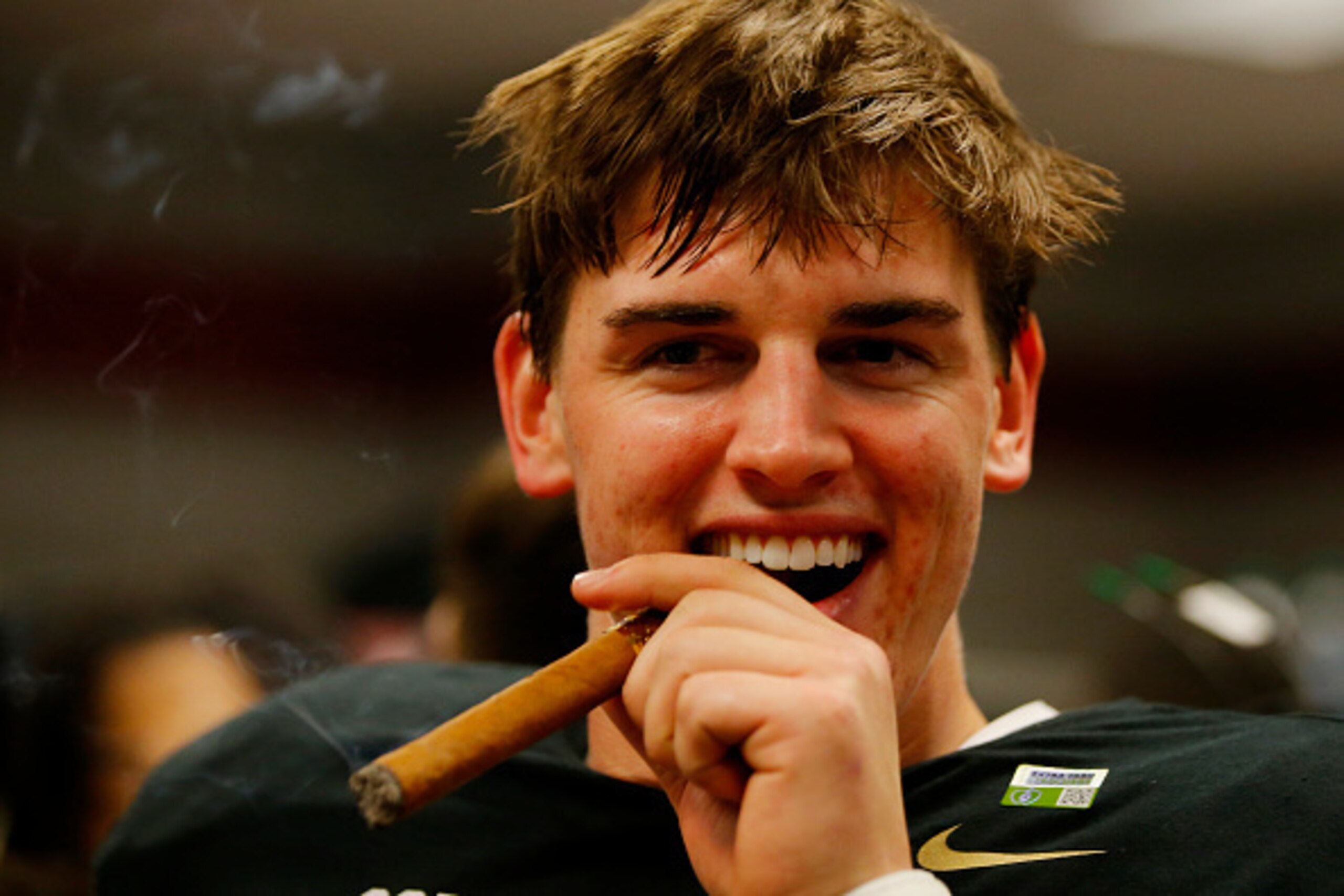 GLENDALE, AZ - JANUARY 11:  Jake Coker #14 of the Alabama Crimson Tide celebrates by smoking a cigar after defeating the Clemson Tigers 45-40 in the 2016 College Football Playoff National Championship Game at University of Phoenix Stadium on January 11, 2