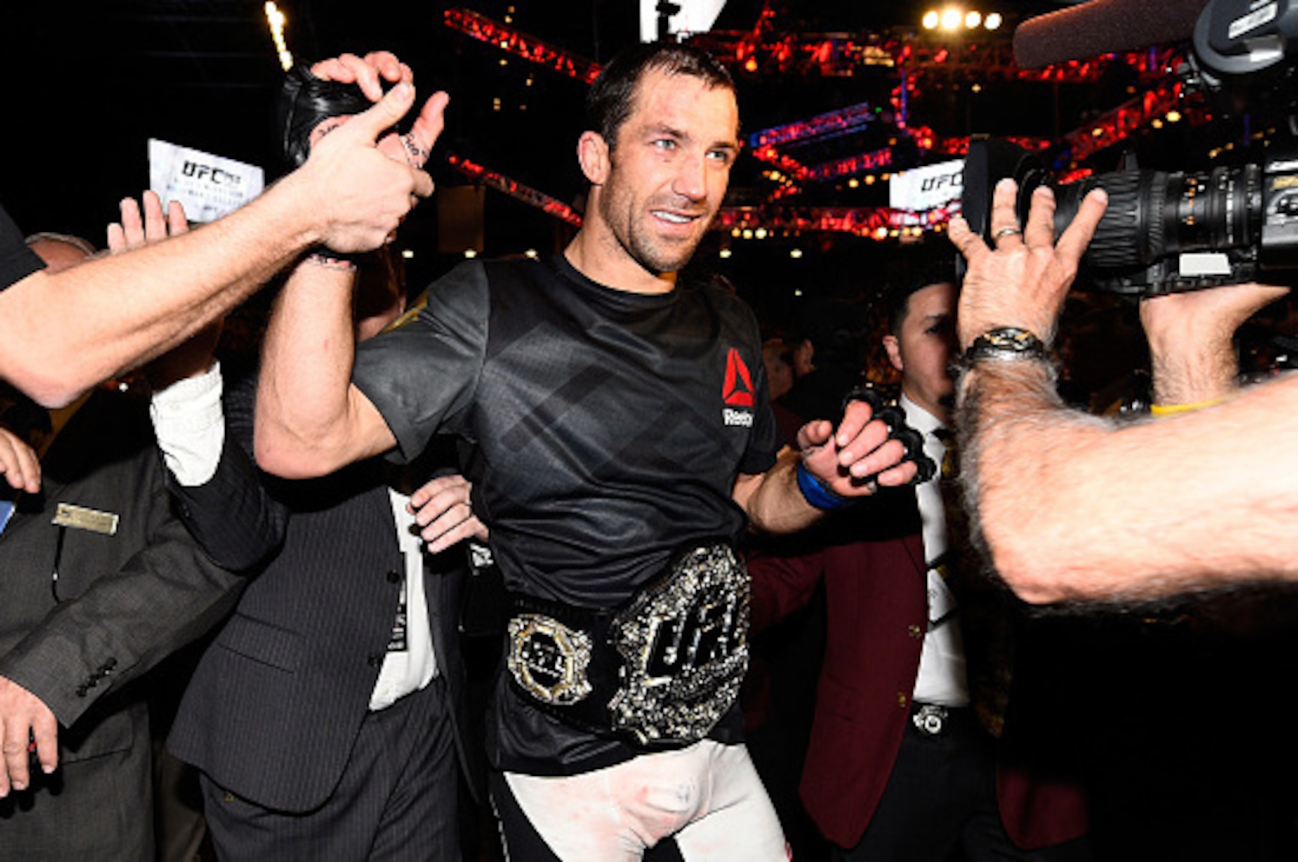 LAS VEGAS, NEVADA - DECEMBER 12:  UFC middleweight champion Luke Rockhold celebrates withs fans after defeating Chris Weidman in their middleweight championship bout during the UFC 194 event inside MGM Grand Garden Arena on December 12, 2015 in Las Vegas,