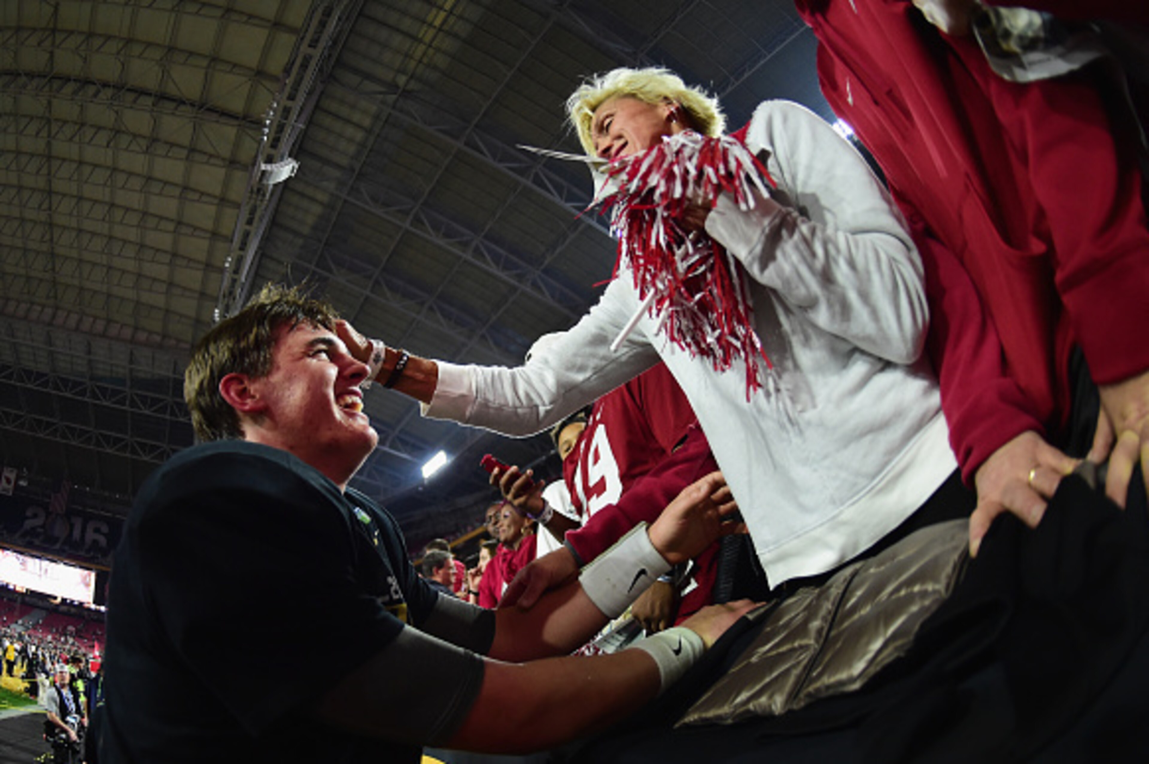 GLENDALE, AZ - JANUARY 11:  Jake Coker #14 of the Alabama Crimson Tide celebrates with his mother Michelle Spires after defeating the Clemson Tigers in the 2016 College Football Playoff National Championship Game at University of Phoenix Stadium on Januar