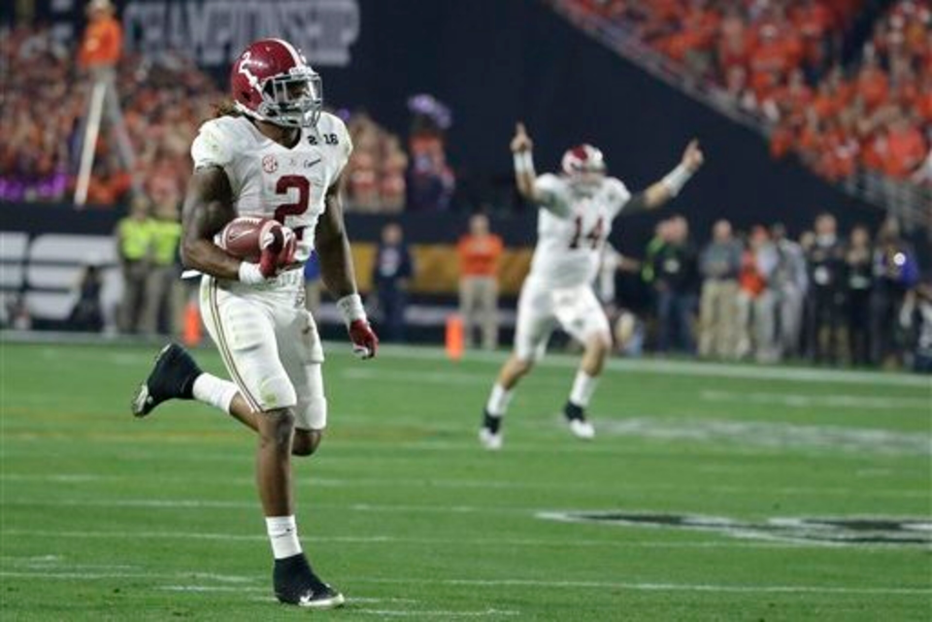 Jake Coker, in the background, celebrates Alabama's first touchdown by Derrick Henry.