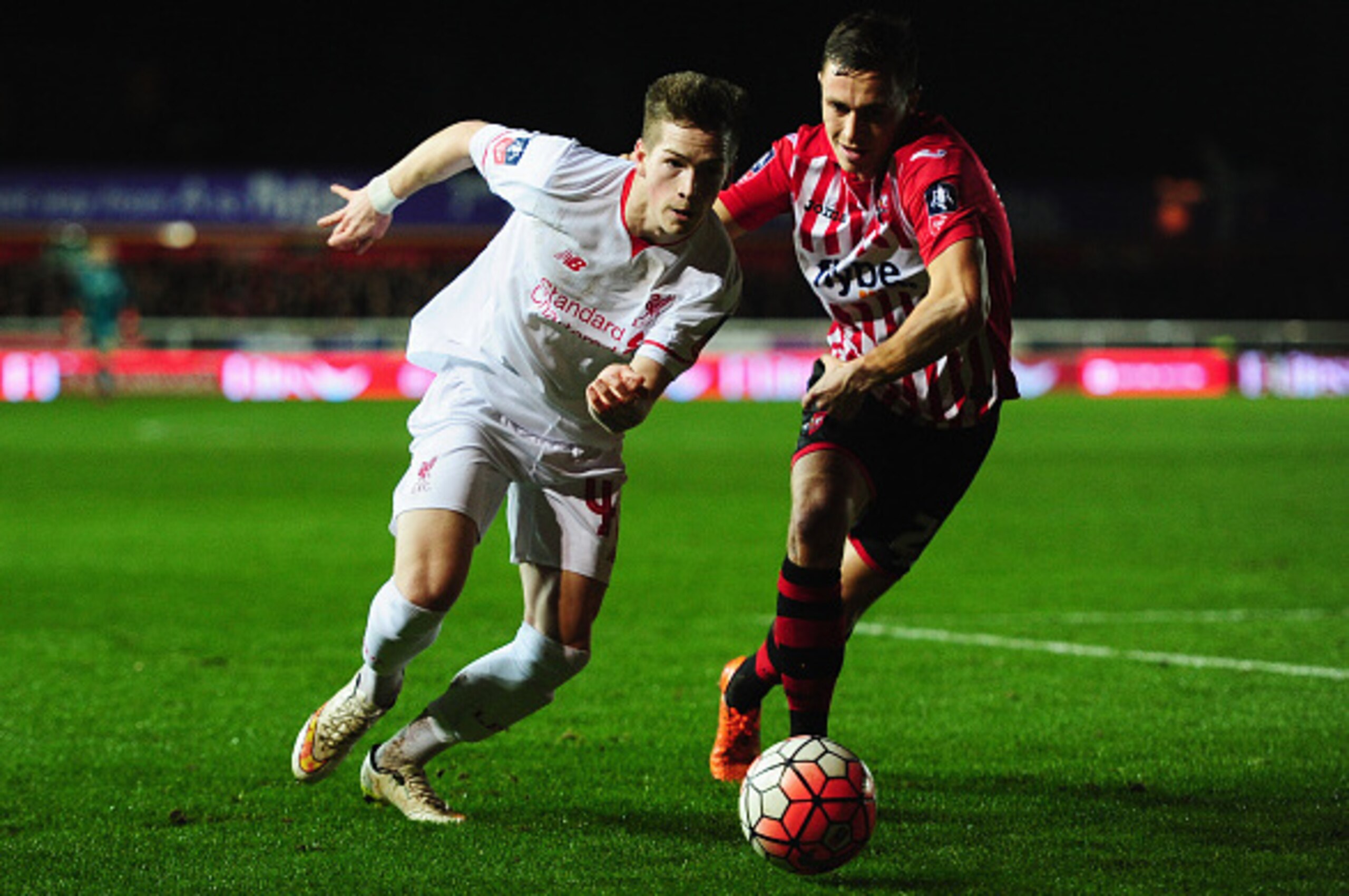 EXETER, ENGLAND - JANUARY 08:  Ryan Kent of Liverpool takes on Jordan Tillson of Exeter City during the Emirates FA Cup third round match between Exeter City and Liverpool at St James Park on January 8, 2016 in Exeter, England.  (Photo by Dan Mullan/Getty
