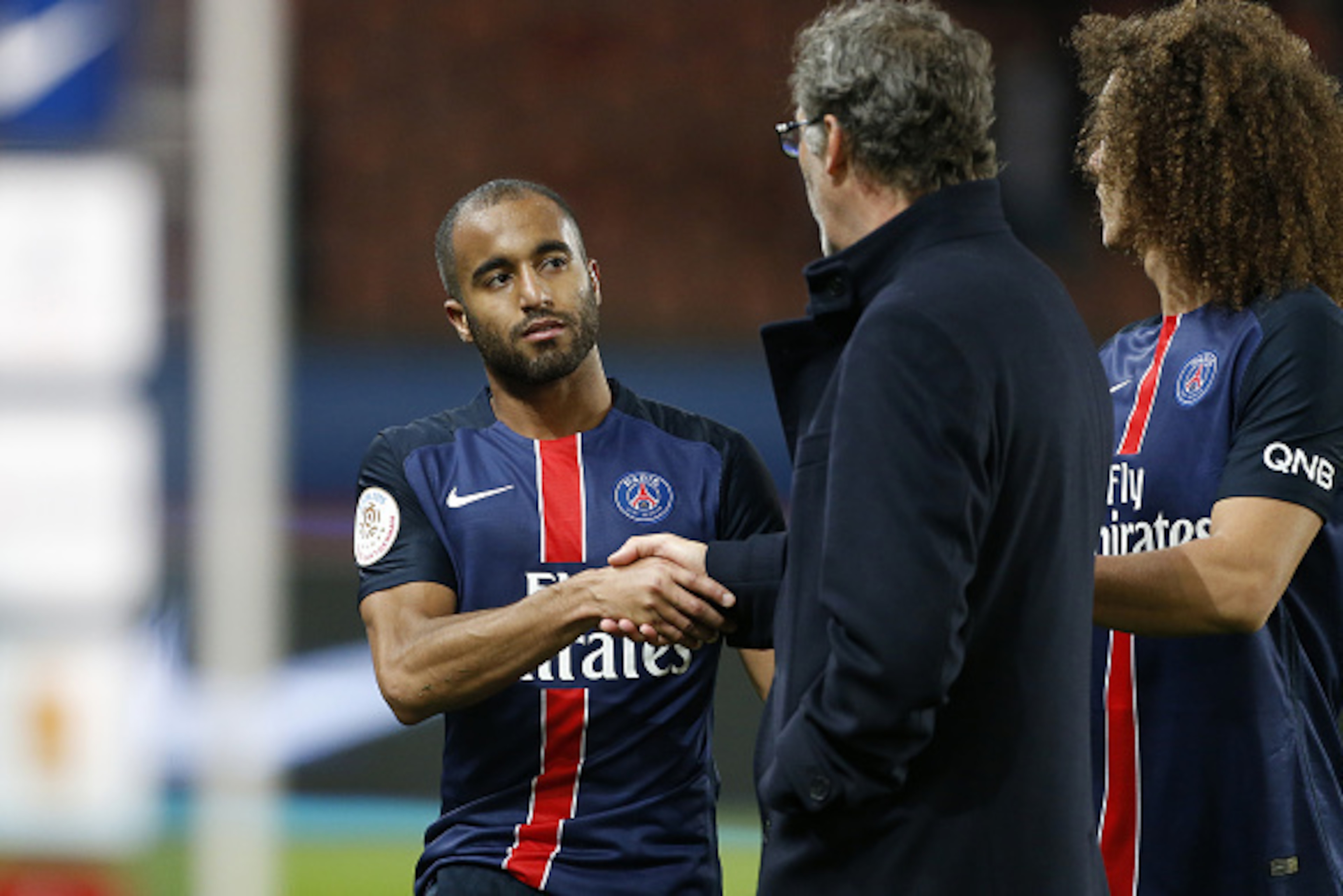 PARIS, FRANCE - JANUARY 8: Lucas Moura of PSG greets coach of PSG Laurent Blanc after the French Ligue 1 match between Paris Saint-Germain (PSG) and Sporting Club de Bastia (SC Bastia) at Parc des Princes stadium on January 8, 2016 in Paris, France. (Phot