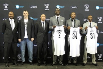 BROOKLYN, NY - July 18: General Manager Billy King, majority owner Mikhail Prokhorov, Head Coach Jason Kidd, Kevin Garnett #2, Paul Pierce #34, and Jason Terry #31 of the Brooklyn Nets pose during a press conference at the Barclays Center on July 18, 2013