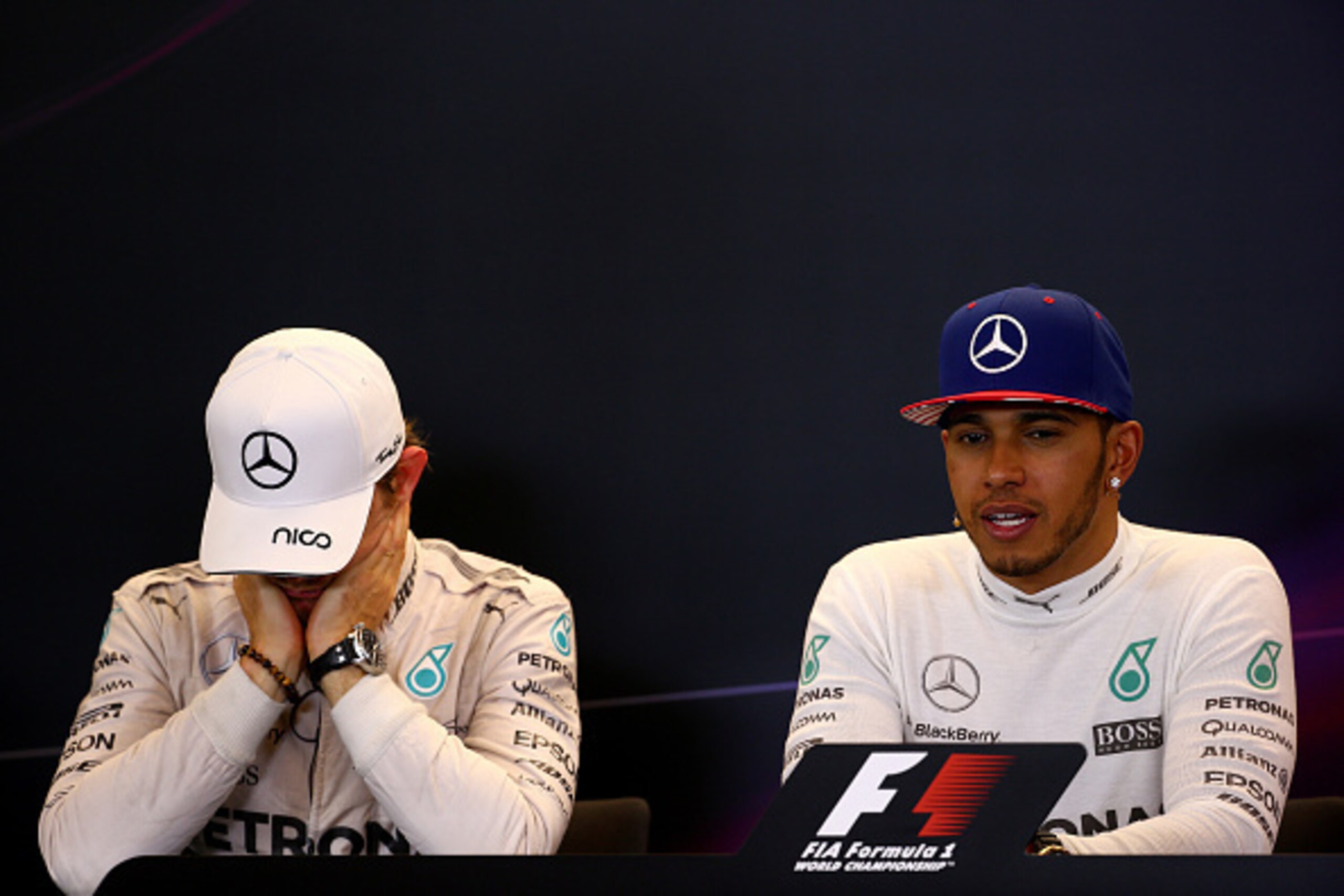 AUSTIN, TX - OCTOBER 25:  Lewis Hamilton of Great Britain and Mercedes GP smiles next to a dejected Nico Rosberg of Germany and Mercedes GP in a press conference after winning the United States Formula One Grand Prix and the championship at Circuit of The
