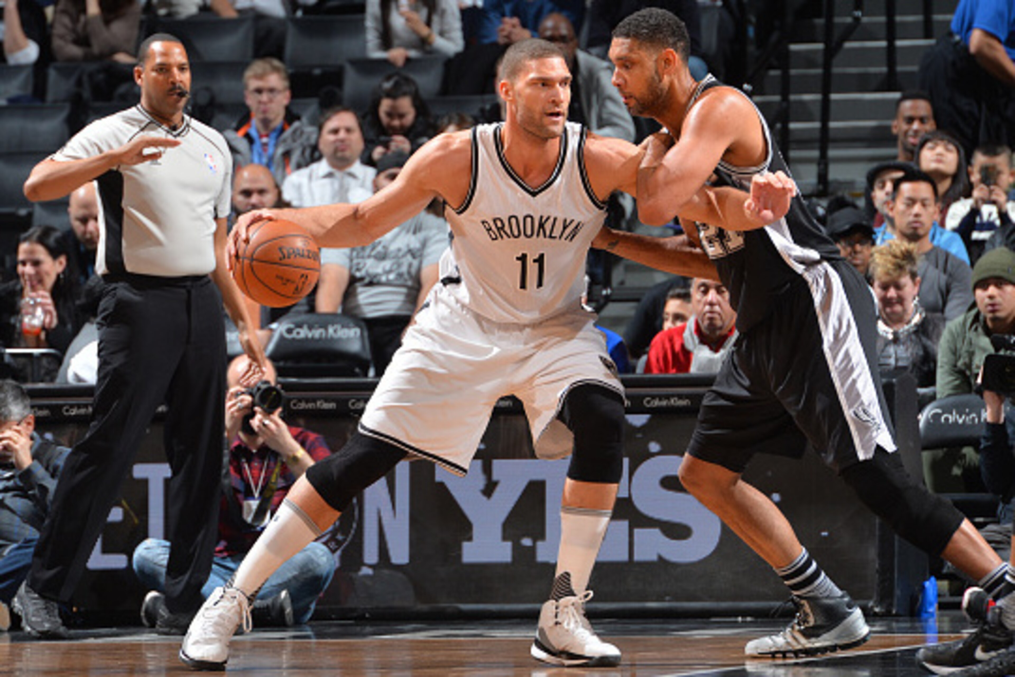 BROOKLYN, NY - JANUARY 11: Brook Lopez #11 of the Brooklyn Nets backs up to the basket against Tim Duncan #21 of the San Antonio Spurs on January 11, 2015 at Barclays Center in Brooklyn, New York. NOTE TO USER: User expressly acknowledges and agrees that, BROOKLYN, NY - JANUARY 11: Brook Lopez #11 of the Brooklyn Nets backs up to the basket against Tim Duncan #21 of the San Antonio Spurs on January 11, 2015 at Barclays Center in Brooklyn, New York. NOTE TO USER: User expressly acknowledges and agrees that,