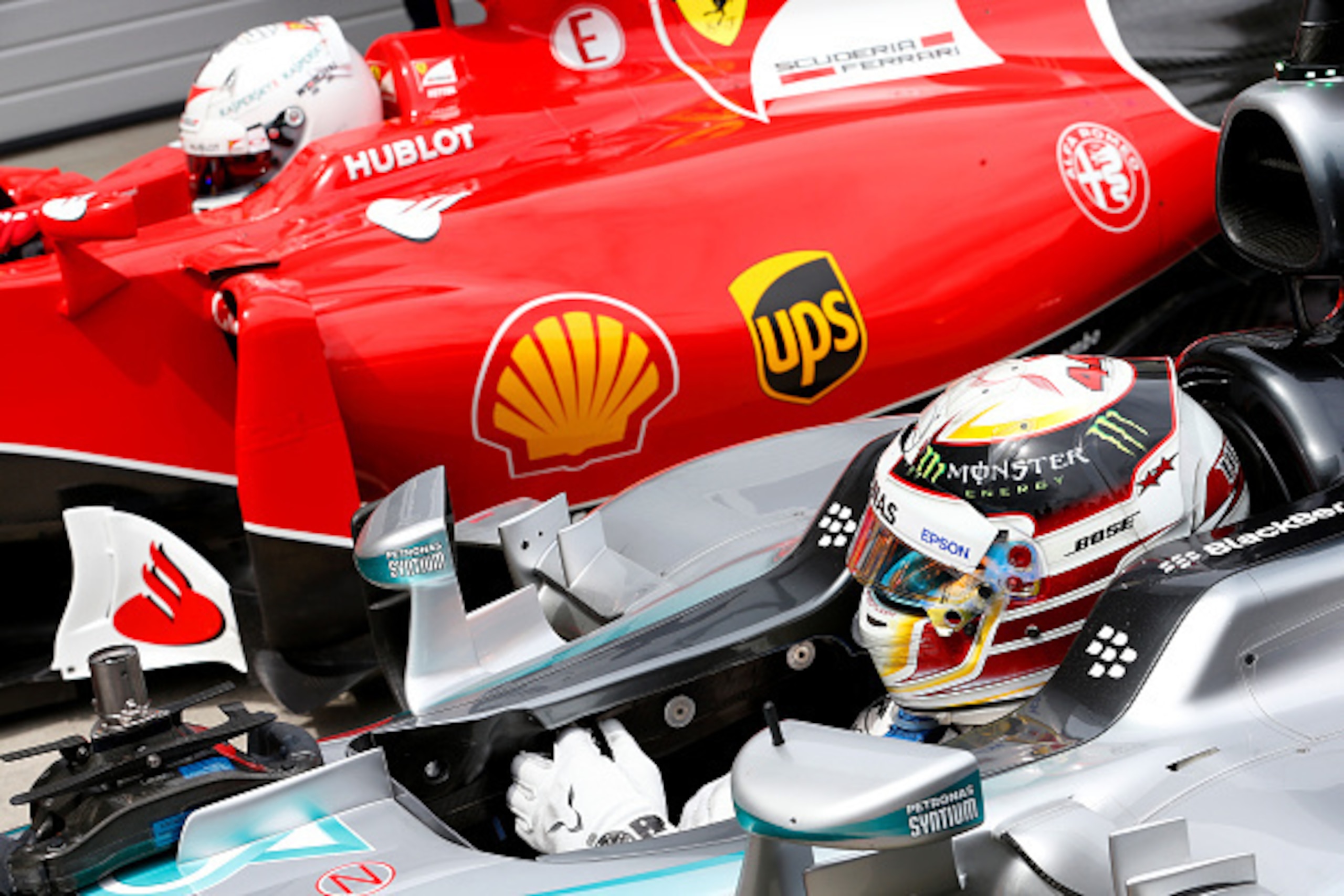 SPIELBERG, AUSTRIA - JUNE 20:  Lewis Hamilton of Great Britain and Mercedes GP gets out of his car in Parc Ferme next to Sebastian Vettel of Germany and Ferrari after claiming pole position during qualifying for the Formula One Grand Prix of Austria at Re