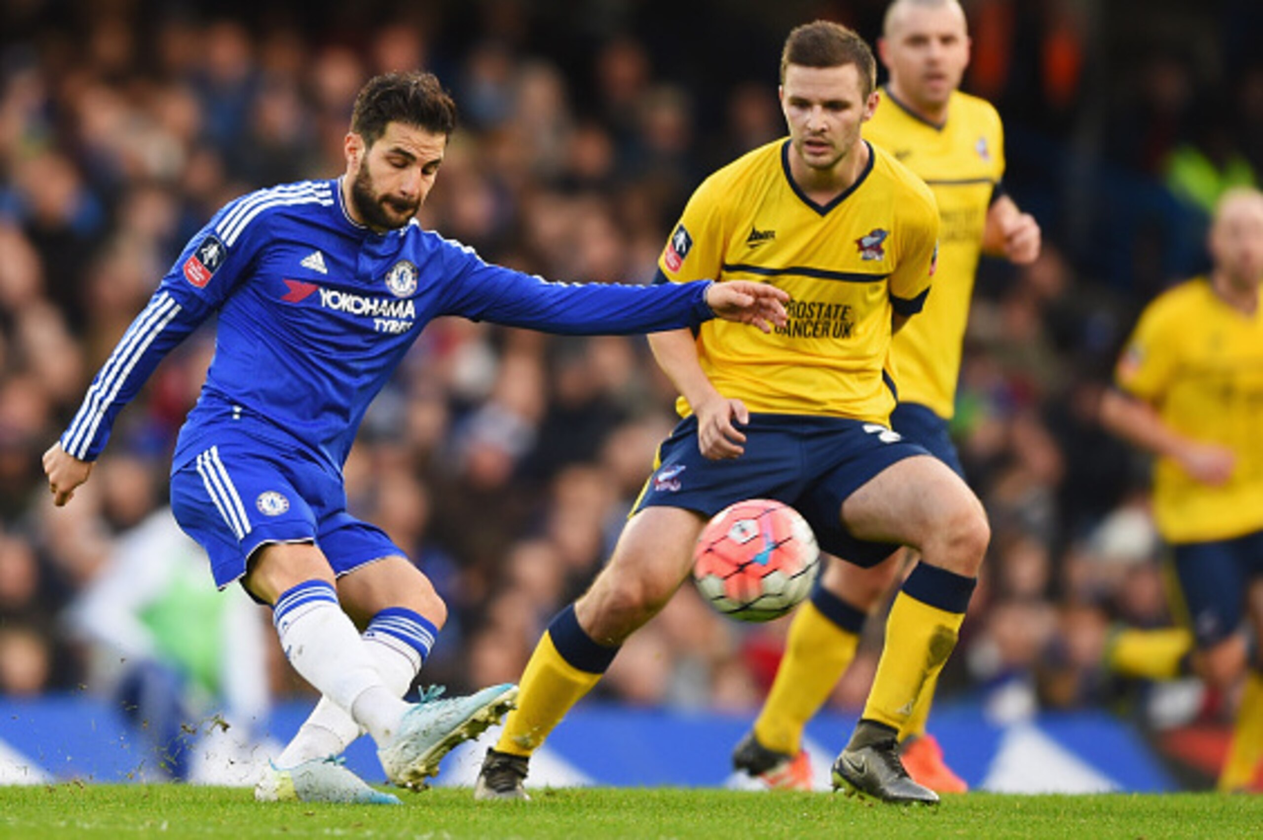 LONDON, ENGLAND - JANUARY 10:  Cesc Fabregas of Chelsea is watched by Jamie Ness of Scunthorpe United during the Emirates FA Cup third round match between Chelsea and Scunthorpe United at Stamford Bridge on January 10, 2016 in London, England.  (Photo by 