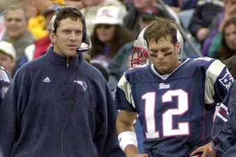 FOXBORO, UNITED STATES:  Quarterback Tom Brady (R) stands on the sidelines with injured Quarterback Drew Bledsoe of the New England Patriots during the first quarter of action against the San Diego Chargers 14 October 2001 in Foxboro Stadium in Foxboro, M