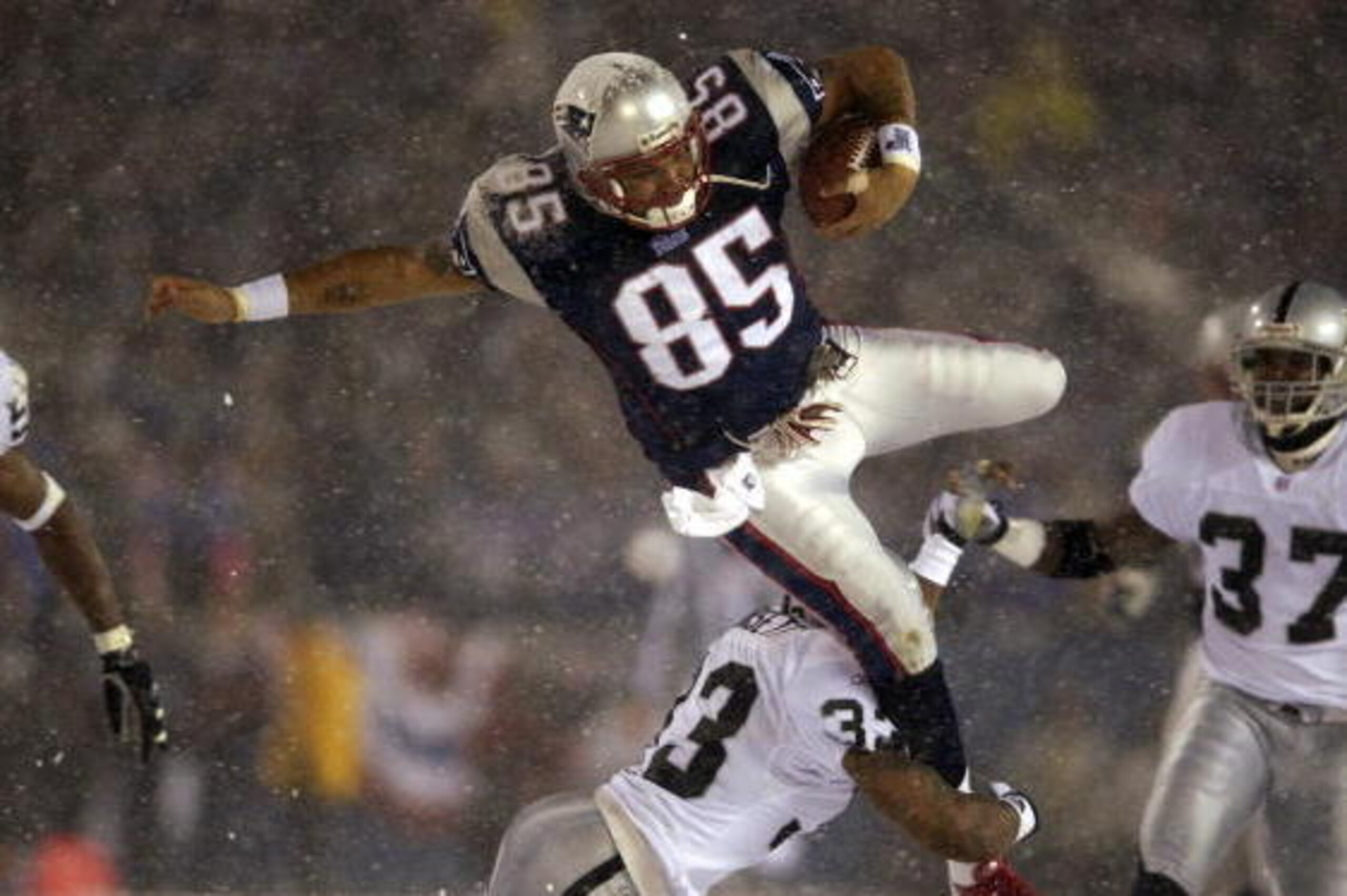 19 Jan 2002: Jermaine Wiggins #85 of the New England Patriots flies through the air when trying to jump over Anthony Dorsett #33 of the Oakland Raiders during the AFC playoff game at Foxboro Stadium in Foxboro, Massachuesetts. The Patriots came from behi 19 Jan 2002: Jermaine Wiggins #85 of the New England Patriots flies through the air when trying to jump over Anthony Dorsett #33 of the Oakland Raiders during the AFC playoff game at Foxboro Stadium in Foxboro, Massachuesetts. The Patriots came from behi