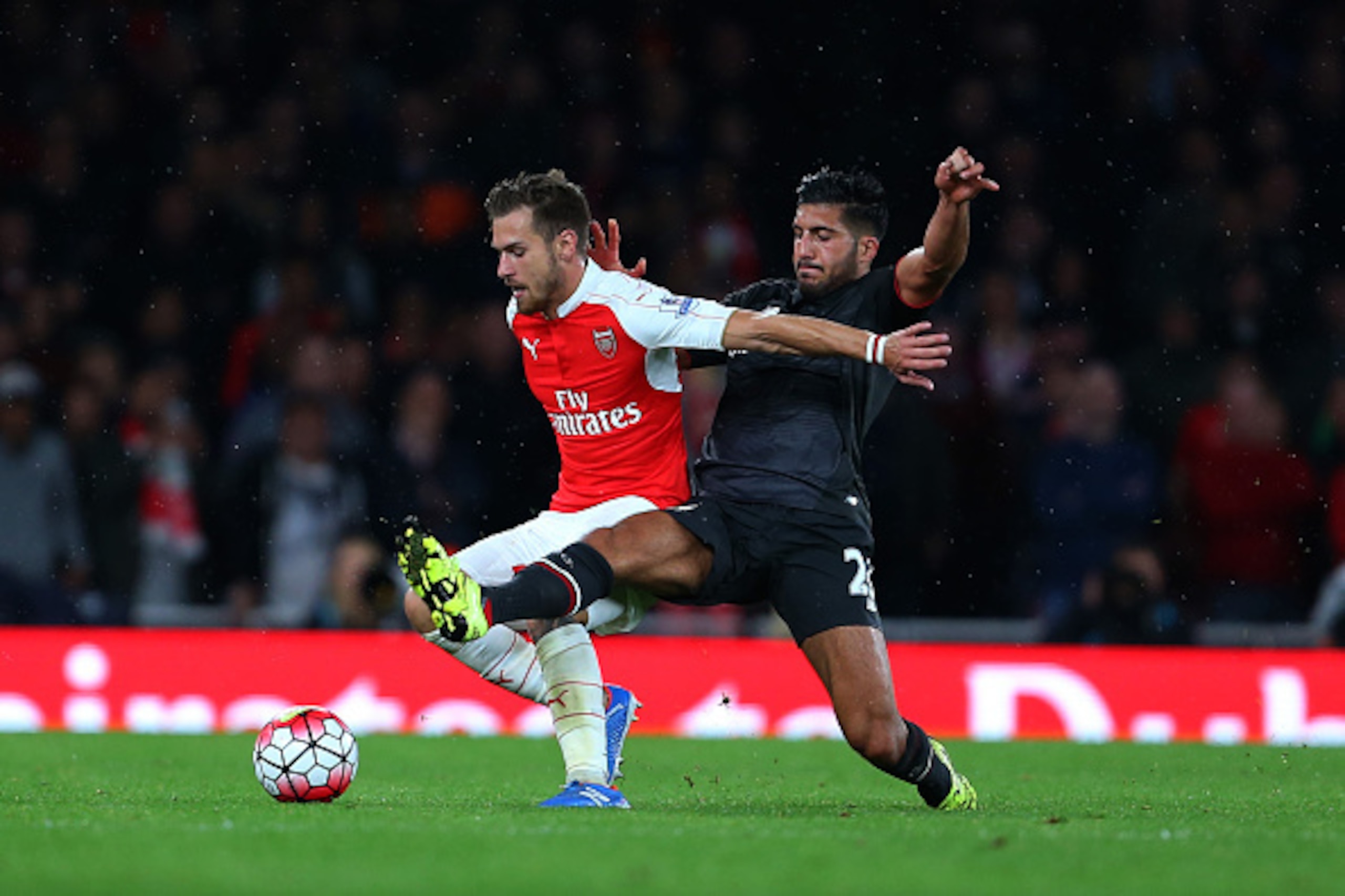 LONDON, ENGLAND - AUGUST 24:  Emre Can of Liverpool tackles Aaron Ramsey of Arsenal during the Barclays Premier League match between Arsenal and Liverpool at the Emirates Stadium on August 24, 2015 in London, United Kingdom.  (Photo by Catherine Ivill - A