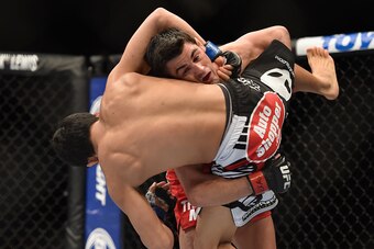 LAS VEGAS, NV - SEPTEMBER 27:  Dominick Cruz takes down Takeya Mizugaki in their bantamweight fight during the UFC 178 event inside the MGM Grand Garden Arena on September 27, 2014 in Las Vegas, Nevada.  (Photo by Jeff Bottari/Zuffa LLC/Zuffa LLC via Gett