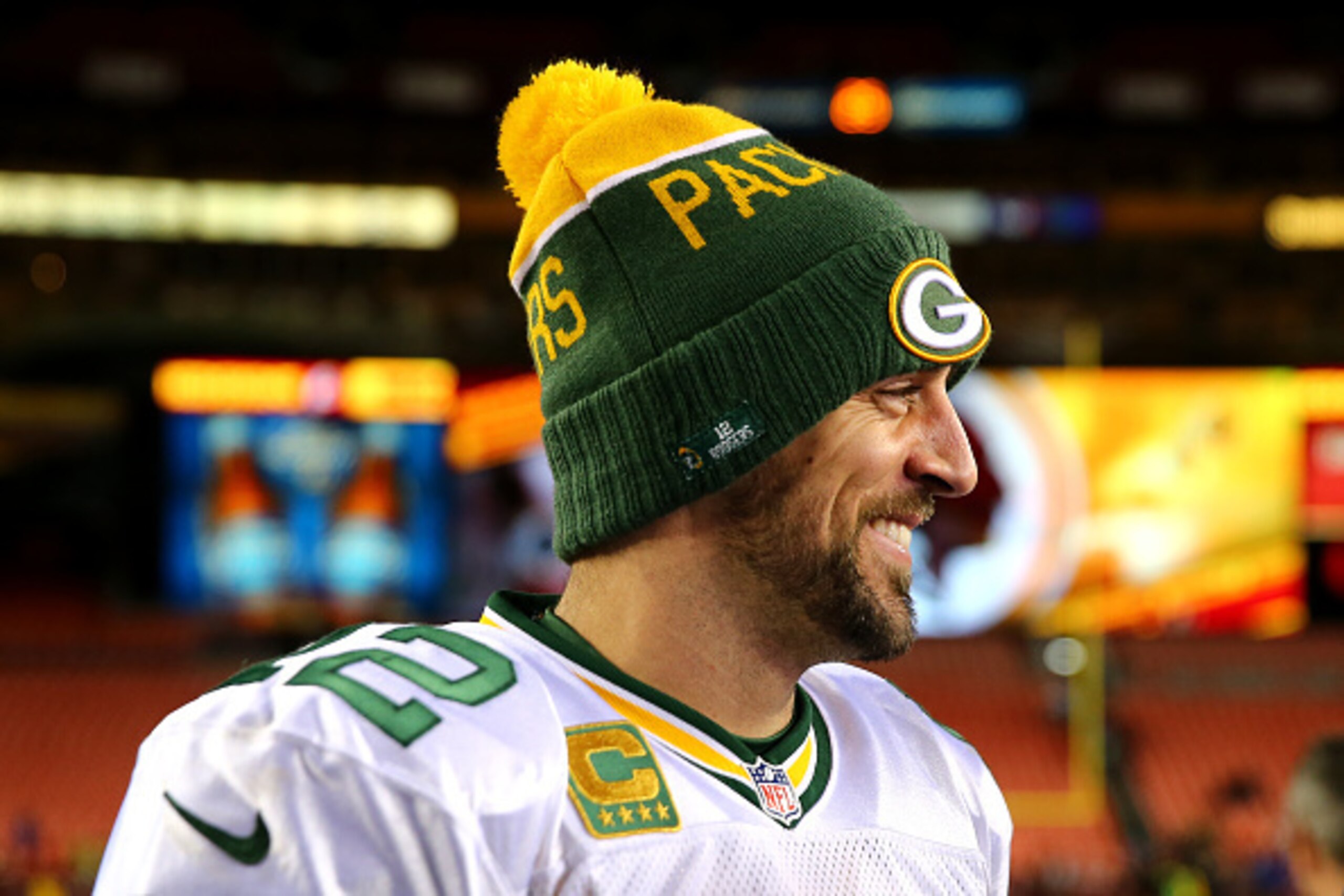 LANDOVER, MD - JANUARY 10: Quarterback Aaron Rodgers #12 of the Green Bay Packers smiles during a post game interview after the Green Bay Packers defeated the Washington Redskins 35-18 during the NFC Wild Card Playoff game at FedExField on January 10, 201